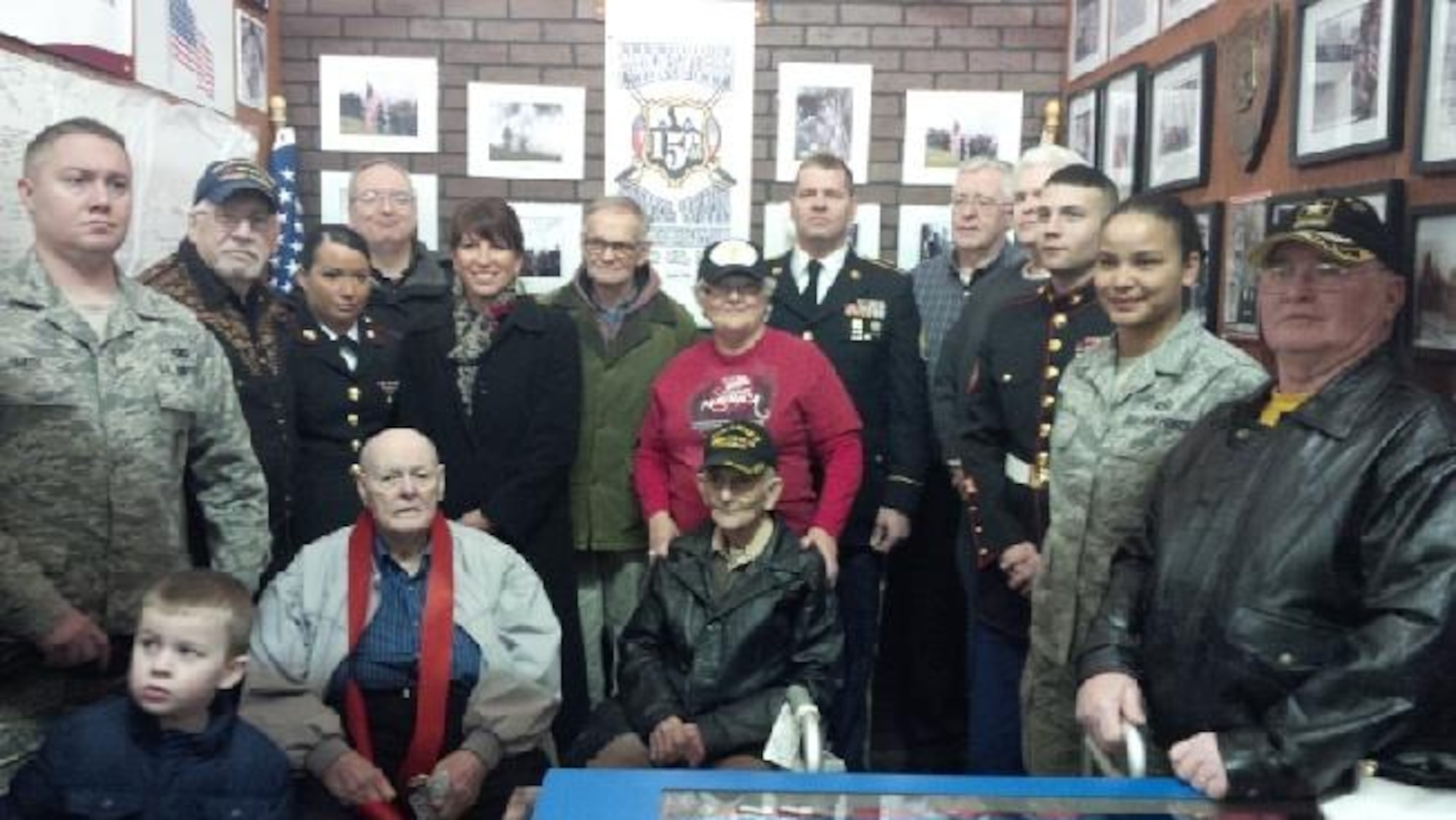 Tech. Sgt. Michael Smith (left) and Staff Sgt. Anastacia Isaacs (second right from right), 332nd Recruiting Squadron H Flight recruiters, attend the  Veteran’s Information Center and Sgt. Mom’s Cantina grand opening ceremony in Elizabethtown, Ky., Feb. 7. Veterans, their families, and active duty members of other military branches attended the ceremony. (U.S. Air Force photo)
