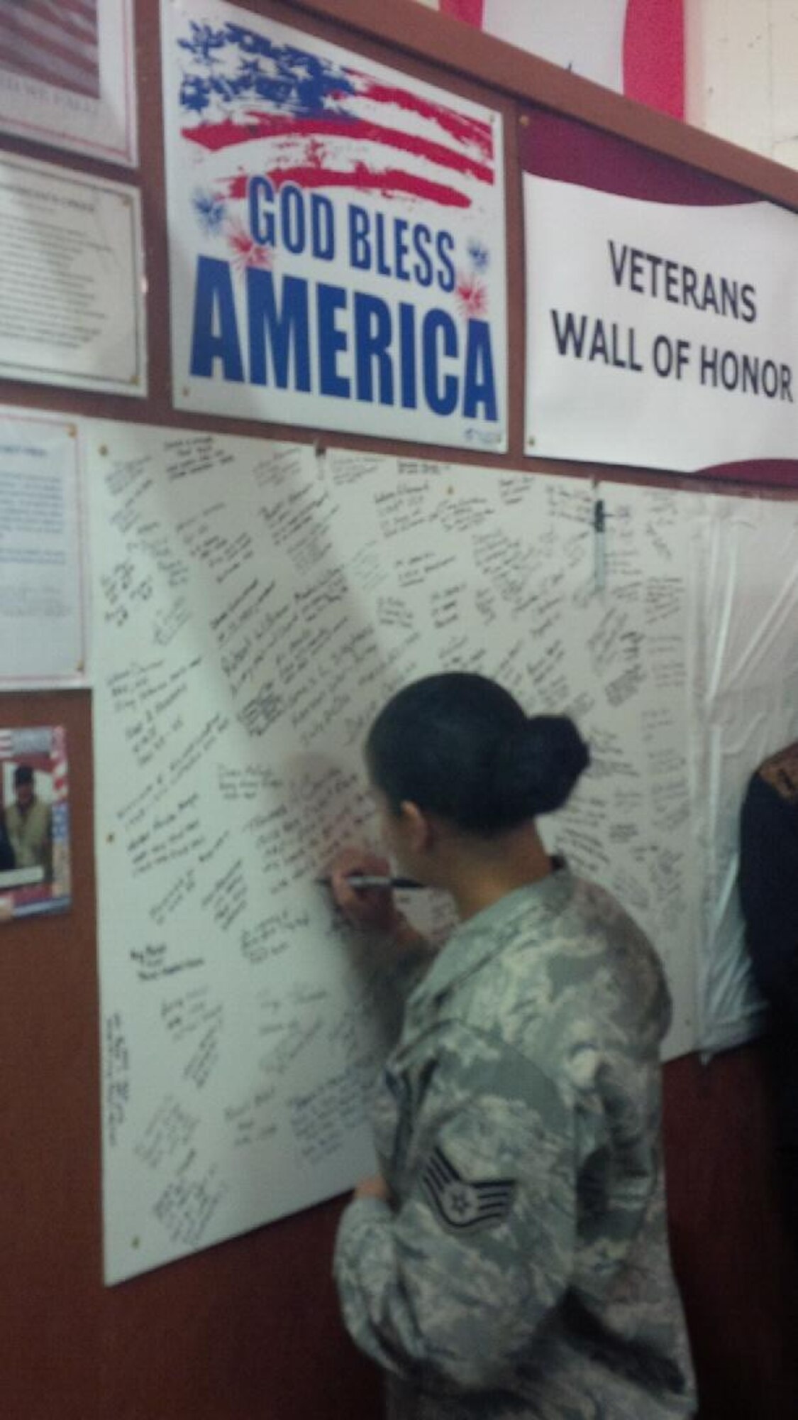 Staff Sgt. Anastacia Isaacs, 332nd Recruiting Squadron H Flight recruiter, signs the  Wall of Honor at the Veterans Information Center and Sgt. Mom’s Cantina grand opening ceremony in Elizabethtown, Ky., Feb. 7. (U.S. Air Force photo/Tech. Sgt. Michael Smith)

