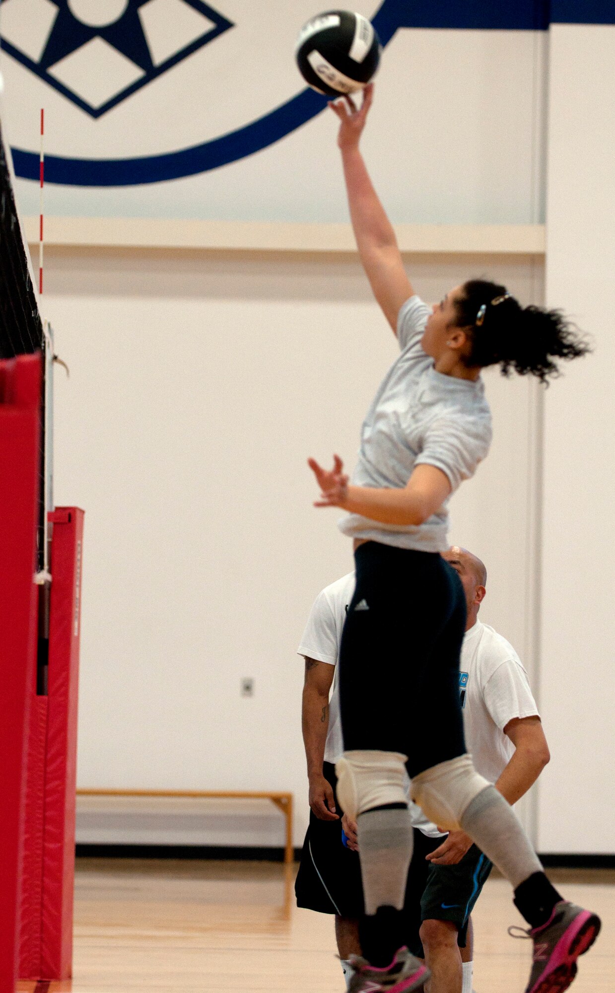 Kanishia Easton, 90th Force Support Squadron volleyball team member, leaps into the air to return an incoming ball back to the opposing team during an intramural volleyball game in the Freedom Hall Fitness Center March 18, 2014. The 90th FSS volleyball team currently has 5 wins and 2 losses. (U.S. Air Force photo by Airman Malcolm Mayfield)