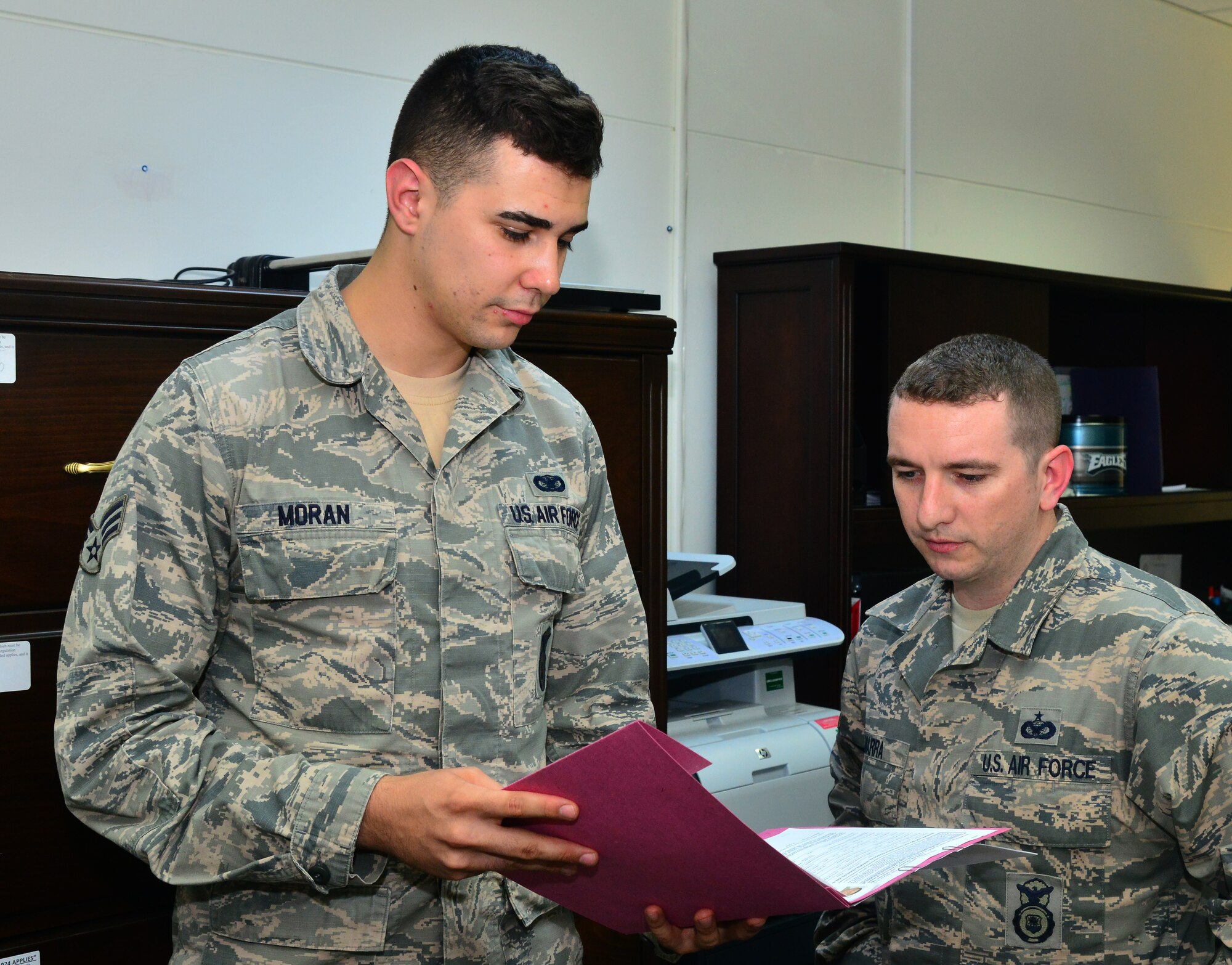 Senior Airman Jose Moran, 39th Security Forces Squadron assistant NCO in charge of Pass and Identification, and Tech. Sgt. Ryan Marra, 39th SFS NCO in charge of Pass and ID, review vehicle registration documentation March 20, 2014, Incirlik Air Base, Turkey. The pass and ID office used Air Force Smart Operations for the 21st Century concepts to help save Airmen $125 in fees for registering and deregistering vehicles.  (U.S. Air Force photo by Staff Sgt. Eric Summers Jr./Released)