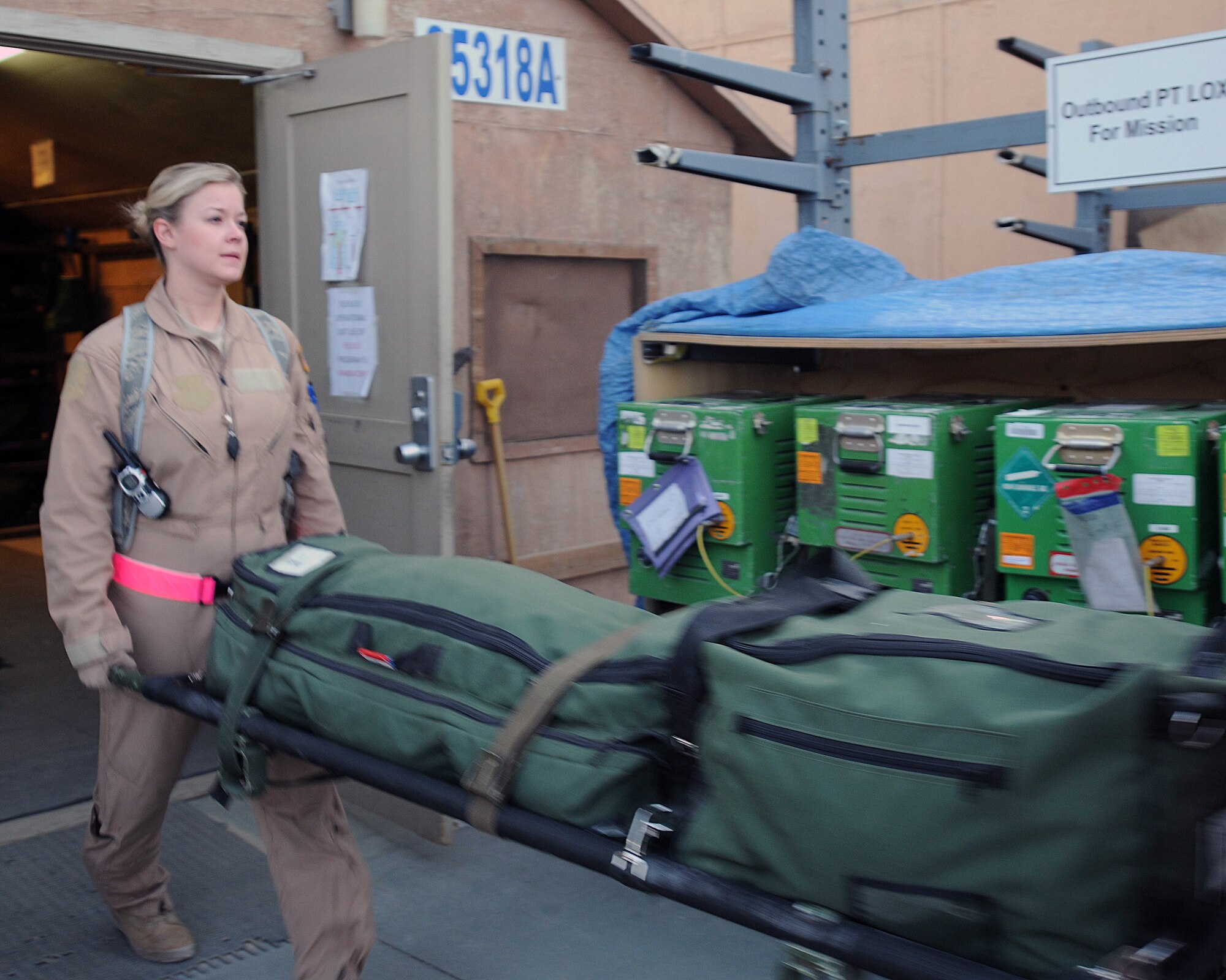 Staff Sgt. Laura Zulkosky, 455th Expeditionary Aeromedical Evacuation Flight third medical technician, carries a litter to be loaded onto a C-130 Hercules at Bagram Air Field, Afghanistan, June 28, 2011. (Photo by Senior Airman Krista Rose)