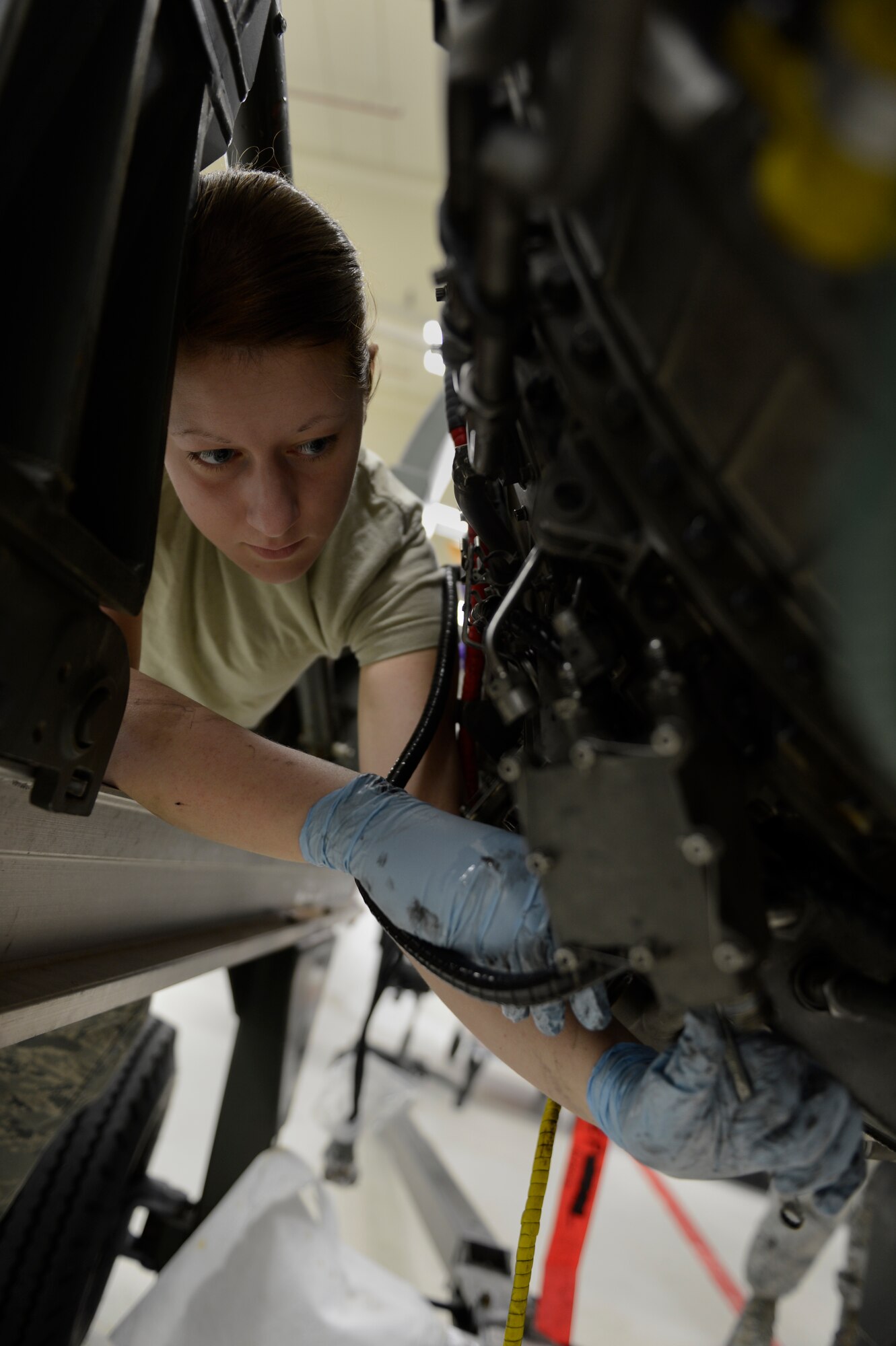 U.S. Air Force Airman 1st Class Jessie Rumbaugh, 52nd Component Maintenance Squadron aerospace propulsion apprentice from Terreton, Idaho, removes a T4B pyrometer off of an F-16 Fighting falcon fighter aircraft engine from Aviano Air Base, Italy, March 18, 2014, at Spangdahlem Air Base Germany. A pyrometer is an instrument to measure the temperature of internal engine components. (U.S. Air Force photo by Staff Sgt. Christopher Ruano/Released)