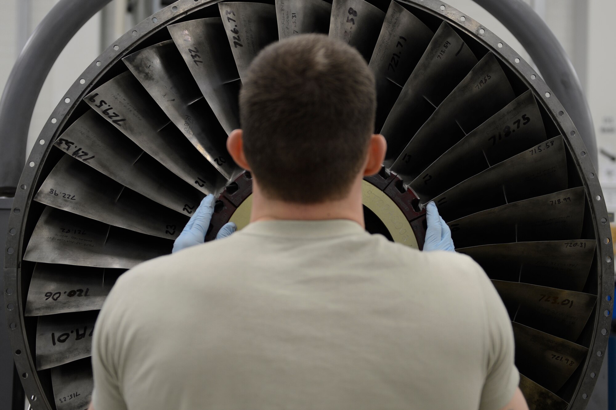 U.S. Air Force Senior Airman Kyle Watson, 52nd Component Maintenance Squadron aerospace propulsion journeyman from Sanford, N.C., installs stage-one fan blades on an F-16 Fighting Falcon fighter aircraft engine, March 18, 2014, at Spangdahlem Air base, Germany. Watson repaired and replaced the blades to balance the engine rotors. (U.S. Air Force photo by Staff Sgt. Christopher Ruano/Released)