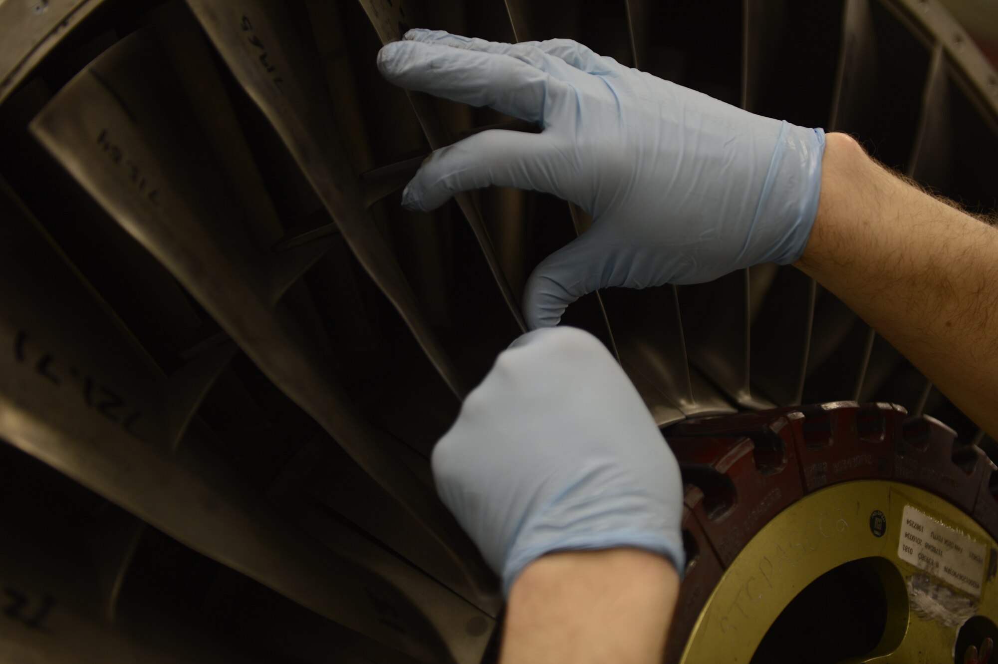 U.S. Air Force Senior Airman Kyle Watson, 52nd Component Maintenance Squadron aerospace propulsion journeyman from Sanford, N.C., installs stage-one fan blades on an F-16 Fighting Falcon fighter aircraft engine, March 18, 2014, at Spangdahlem Air base, Germany. Watson repaired and replaced the blades to balance the engine rotors. (U.S. Air Force photo by Staff Sgt. Christopher Ruano/Released)