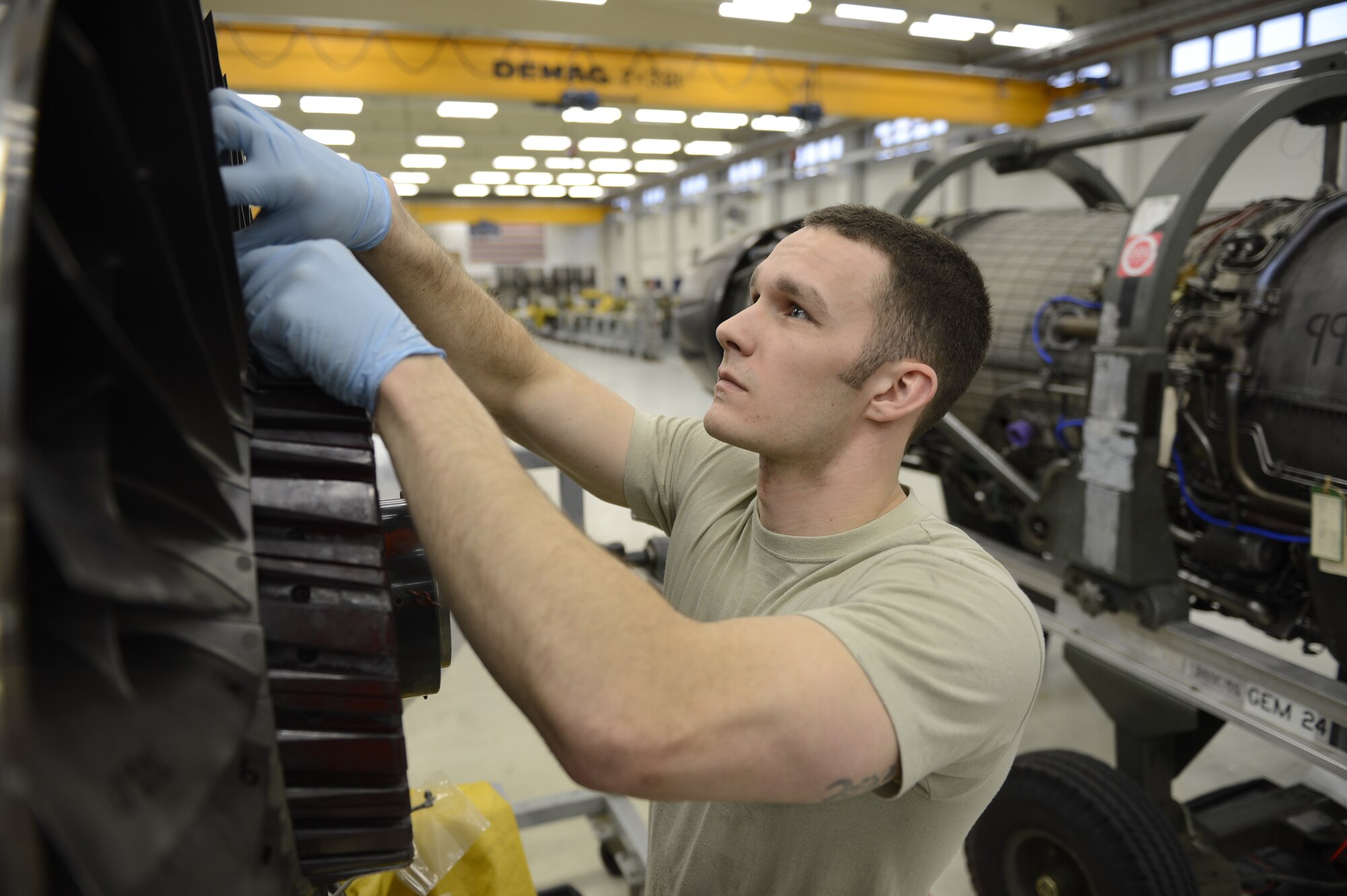 U.S. Air Force Senior Airman Kyle Watson, 52nd Component Maintenance Squadron aerospace propulsion journeyman from Sanford, N.C., installs stage-one fan blades on an F-16 Fighting Falcon fighter aircraft engine, March 18, 2014, at Spangdahlem Air Base, Germany. On average it takes up to four hours to remove, repair and reinstall the engine blades.  (U.S. Air Force photo by Staff Sgt. Christopher Ruano/Released)