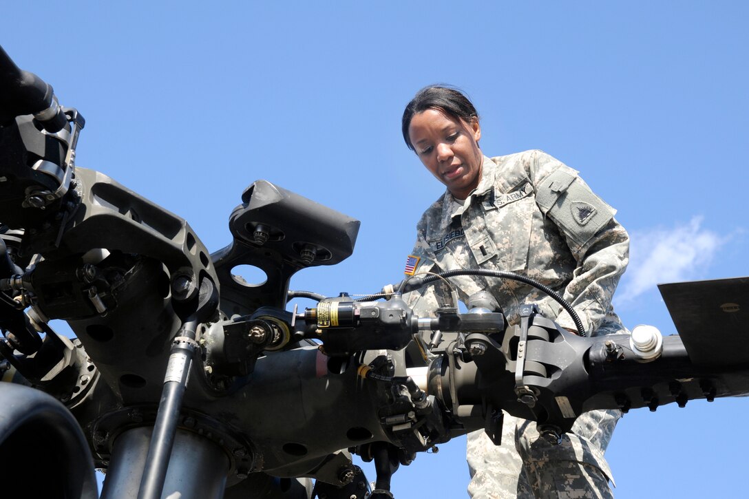Army 1st Lt. Demetria N. Elosiebo conducts preflight checks of rotor blades on a UH-60 Black Hawk helicopter for flight on Davison Army Airfield, Va., March 15, 2014. Elosiebo, a pilot and platoon leader assigned to Company D Air Ambulance, 1st Battalion, 224th Aviation Regiment, is the first female African-American rotary wing pilot in the D.C. National Guard.
