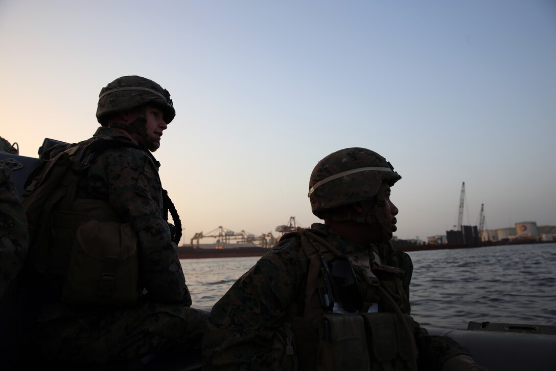 Lance Corporals Jacob Haygood and Bolivar Barcenas, both infantrymen from Marine Forces Europe and Africa, ride a rigid-hull inflatable boat from the joint high-speed vessel USNS Spearhead, March 5, 2014. The Marines practiced boarding the RHIB with their protective vests and Kevlar helmets before setting out for their actual exercise in order to gain a better understanding of how the RHIB operates. (Official Marine Corps Photo by Sgt. Ed Galo)