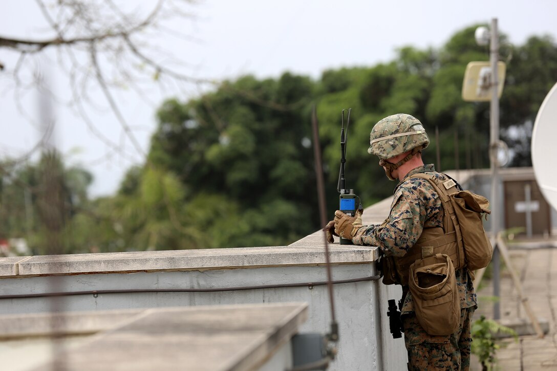 Lance Corporal Jacob Haygood, an infantryman from Marine Forces Europe and Africa, provides an over watch for Marines conducting vehicle inspections at the American Embassy in Monrovia, Liberia, during a training exercise March 7, 2014. The Marines conducted the training in order to test the capabilities of the Spearhead and to prepare response forces for potential situations of regional instability and strengthen interagency coordination between U.S. and the Liberian government and military. (Official Marine Corps Photo by Sgt. Ed Galo)