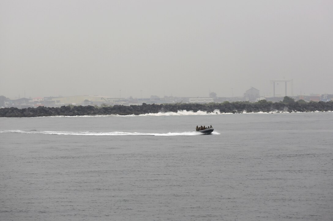 Marines from Marine Forces Europe and Africa ride a rigid-hull inflatable boat back to the joint high-speed vessel USNS Spearhead after completing a training exercise in Monrovia, Liberia, March 7, 2014. The Marines conducted the training in order to test the capabilities of the Spearhead and to prepare response forces for potential situations of regional instability and strengthen interagency coordination between U.S. and the Liberian government and military. (Official Marine Corps Photo by Sgt. Ed Galo)