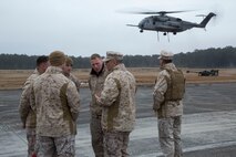 Col. Clifford J. Weinstein (center), the commanding officer of 10th Marine Regiment, 2nd Marine Division, speaks to Marines with Combat Logistics Regiment 2, 2nd Marine Logistics Group, II Marine Expeditionary Force during a Helicopter Support Team exercise at Davis Airfield aboard Camp Lejeune, N.C., March 19, 2014. 1st Battalion, 10th Marines brought two M777 howitzers for 2nd MLG landing support specialists to train with. 