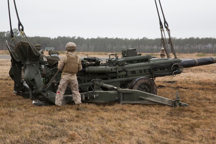 Landing support specialists with Combat Logistics Regiment 2, 2nd Marine Logistics Group, II Marine Expeditionary Force check the cables connecting to a M777 howitzer during a Helicopter Support Team exercise at Davis Airfield aboard Camp Lejeune, N.C., March 19, 2014. A CH-53E Super Stallion from Marine Heavy Helicopter Squadron 461, Marine Aircraft Group 29, Marine Corps Air Station New River, conducted the lifts throughout the training evolution. 