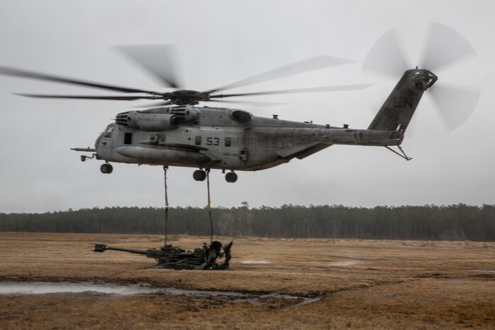 A CH-53E Super Stallion from Marine Heavy Helicopter Squadron 461, Marine Aircraft Group 29, Marine Corps Air Station New River, lifts a M777 howitzer during a Helicopter Support Team exercise at Davis Airfield aboard Camp Lejeune, N.C., March 19, 2014. Landing support specialists with Combat Logistics Regiment 2, 2nd Marine Logistics Group, II Marine Expeditionary Force ensured the cables were connected correctly to the M777 before lifting off. 