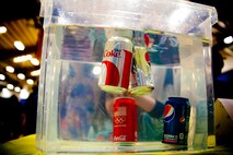 A young visitor to a science fair in Jacksonville, N.C., peers into a water tank filled with cans of soda March 15, 2014. Marines with General Support Maintenance Company, 2nd Maintenance Battalion, 2nd Marine Logistics Group volunteered at several locations throughout the area as a way to give back to the community that surrounds Marine Corps Base Camp Lejeune, N.C.