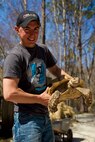 Lance Cpl. Ben Seeger, a Merrill, Wis., native and Marine with General Support Maintenance Company, 2nd Maintenance Battalion, 2nd Marine Logistics Group, shows off a desert tortoise at the Lynwood Park Zoo in Jacksonville, N.C., March 15, 2014. Thirty Marines with the company volunteered time during their weekend at several locations throughout the area as a way to give back to the community that surrounds Marine Corps Base Camp Lejeune, N.C.