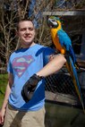 Cpl. Zachary Harrison, a Sevierville, Tenn., native and Marine with General Support Maintenance Company, 2nd Maintenance Battalion, 2nd Marine Logistics Group, shows off a parrot at the Lynwood Park Zoo in Jacksonville, N.C., March 15, 2014. Thirty Marines with the company volunteered time during their weekend at several locations throughout the area as a way to give back to the community that surrounds Marine Corps Base Camp Lejeune, N.C.