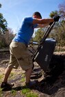 Cpl. Zachary Harrison, a Sevierville, Tenn., native and Marine with General Support Maintenance Company, 2nd Maintenance Battalion, 2nd Marine Logistics Group, helps clear mud from a drainage trench at the Lynwood Park Zoo in Jacksonville, N.C., March 15, 2014. Thirty Marines with the company volunteered time during their weekend at several locations throughout the area as a way to give back to the community that surrounds Marine Corps Base Camp Lejeune, N.C.