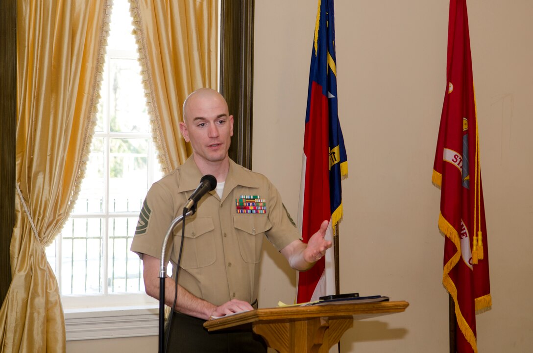 Gunnery Sgt. Zane J. Poe speaks to attendees at a luncheon honoring the Poe family as the New Bern Military Alliance Family of the Quarter at the New Bern, N.C. Golf and Country Club March 13, 2014. The Poe family earned the recognition for their off-duty volunteer efforts in the community. Poe is the metrology and calibration chief and mobile facilities coordinator with Marine Wing Headquarters Squadron 2. 