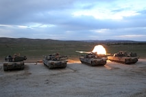 Marines with the tank platoon, Battalion Landing Team 2nd Battalion, 1st Marines (BLT 2/1), part of the 11th Marine Expeditionary Unit, fire the 120mm smoothbore cannon of four M1A1 Abrams tanks during a live-fire training exercise at Fort Hunter Liggett, Calif., March 20. Realistic Urban Training Marine Expeditionary Unit Exercise (RUTMEUEX) 14-1 allows the Marines and sailors of the 11th MEU the opportunity to employ techniques and tactics applicable to their future deployment. RUTMEUEX incorporates the majority of the ground combat element, aviation combat element, logistics combat element and command element of the MEU for the first time in the predeployment cycle. 