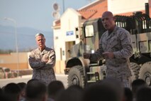The 35th Commandant of the Marine Corps Gen. James F. Amos looks on as Sgt. Maj. of the Marine Corps Micheal P. Barret speaks to the Marines and Sailors of Special-Purpose Marine Air-Ground Task Forces Africa and Crisis Response during a command visit to Naval Air Station Sigonella, Italy, June 16, 2013. The commandant and sergeant major of the Marine Corps spoke to the Marines and Sailors about the importance of their missions. Since deploying in January, Special-Purpose MAGTF Africa has trained over 500 host nation personnel in Africa. (U.S. Marine Corps photo by 2nd Lt. Andrew Bolla/Released)