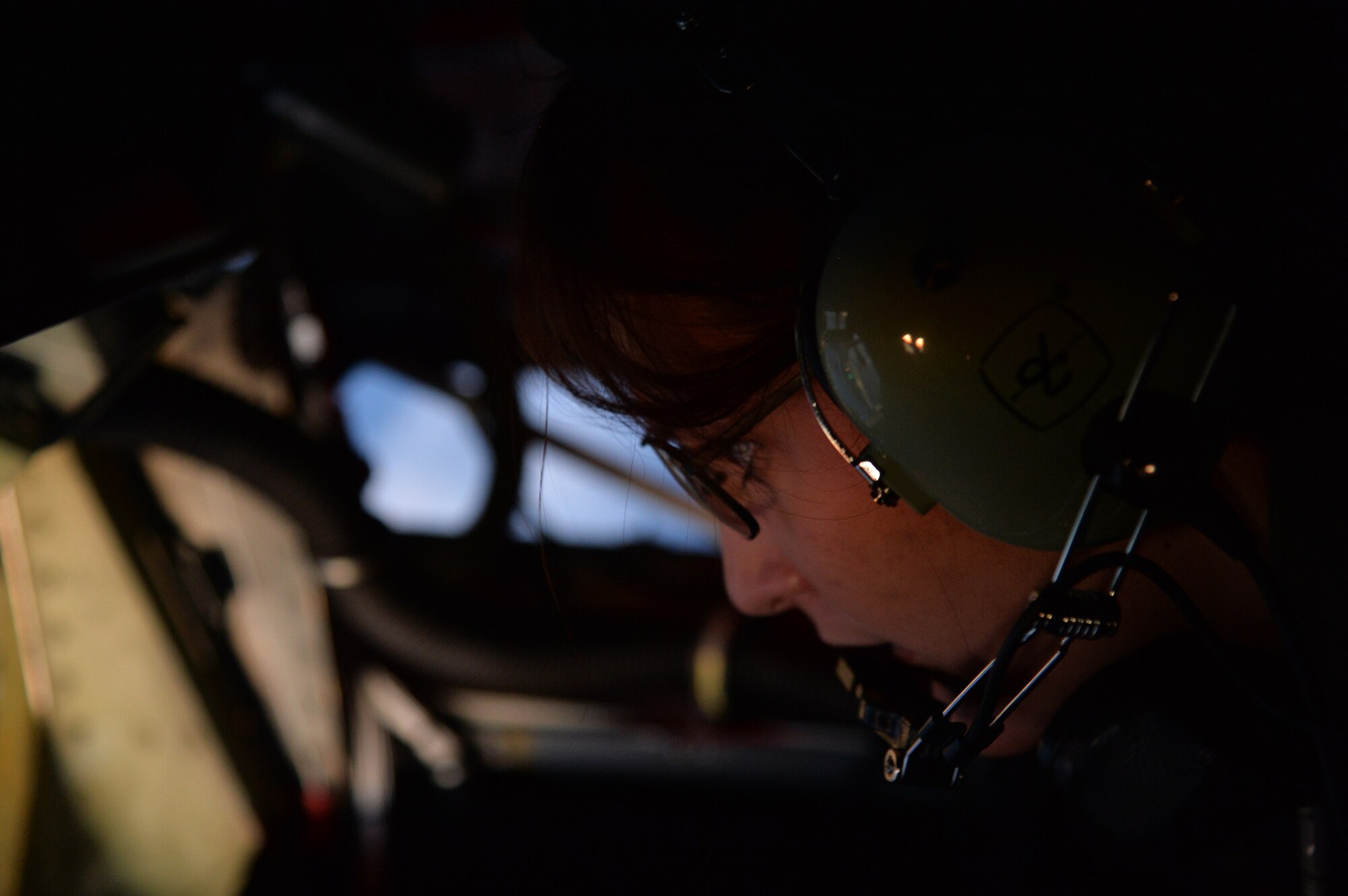 Airman 1st Class Rebekah McCormack, 96th Air Refueling Squadron in-flight refueling specialist, goes over her refueling checklist aboard a KC-135 Stratotanker at Joint Base Pearl Harbor-Hickam, Hawaii, March 20, 2014. During the mission McCormack trained on refueling procedures for a C-17 Globemaster III. (U.S. Air Force photo/Staff Sgt. Alexander Martinez)