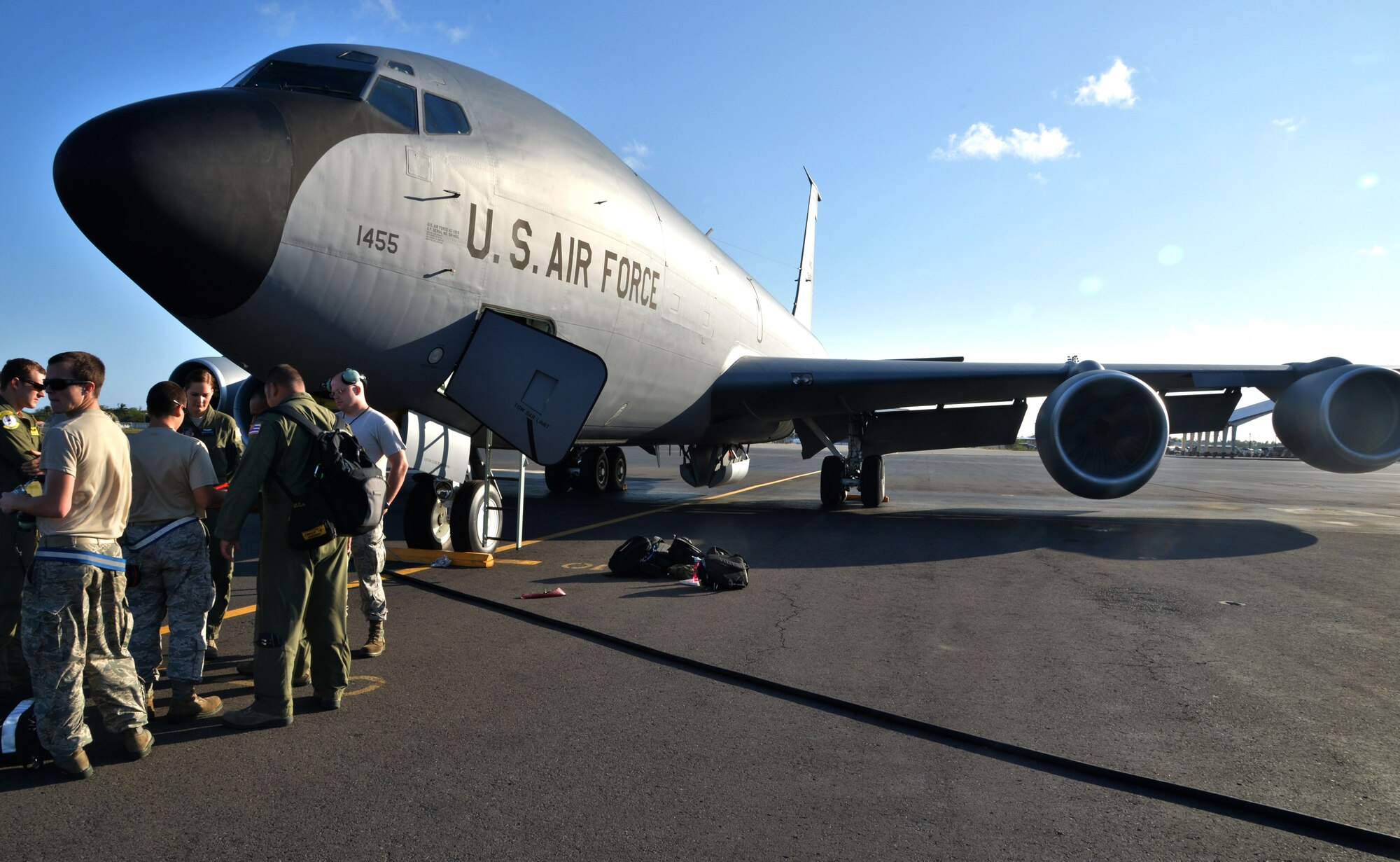 Aircrew and flightline Airmen meet before a mission under the nose of a KC-135 Stratotanker at Joint Base Pearl Harbor-Hickam, Hawaii, March 20, 2014. The flight crew, including Airman 1st Class Rebekah McCormack, 96th Air Refueling Squadron in-flight refueling specialist, trained on refueling procedures for a C-17 Globemaster III. (U.S. Air Force photo/Staff Sgt. Alexander Martinez)