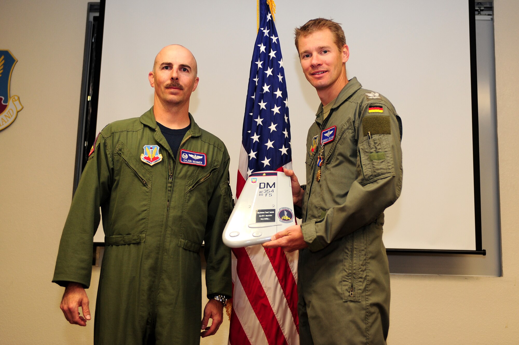 German Maj. Andreas Jeschek, 354th Fighter Squadron assistant director of operations, receives the U.S. Air Medal with three oak leaf clusters at Davis-Monthan Air Force Base, Ariz., March 21, 2014. Jeschek is the first German pilot to fly in combat since World War II. (U.S. Air Force photo by Senior Airman Camilla Elizeu/Released)