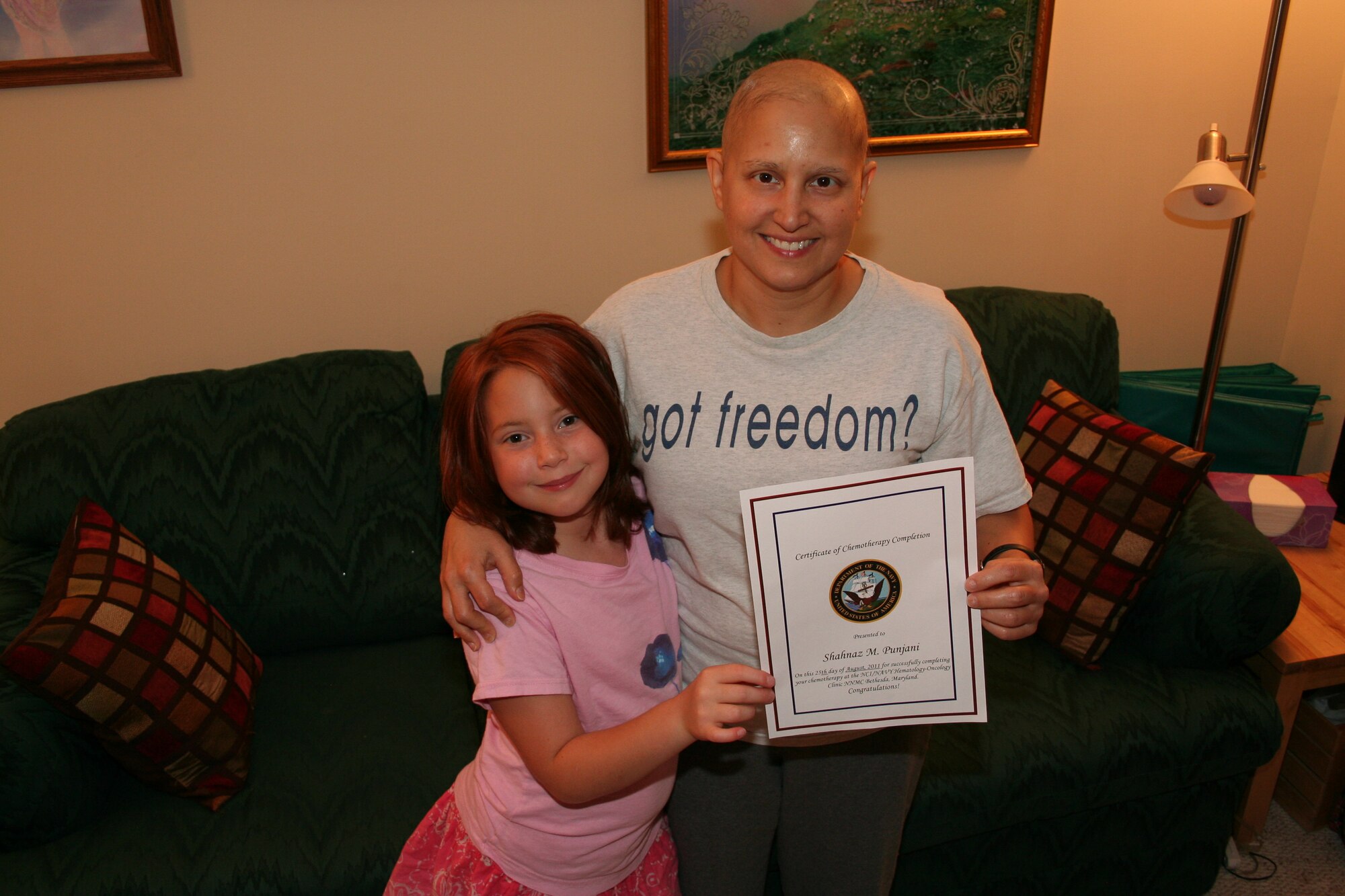 Col. Shahnaz Punjani poses with her certifcate of chemotherapy completion and daughter, Maya, Aug. 25 near Bethesda, Maryland. Punjani was diagnosed with triple-negative Breast Cancer in March 2011. (Courtesy photo)