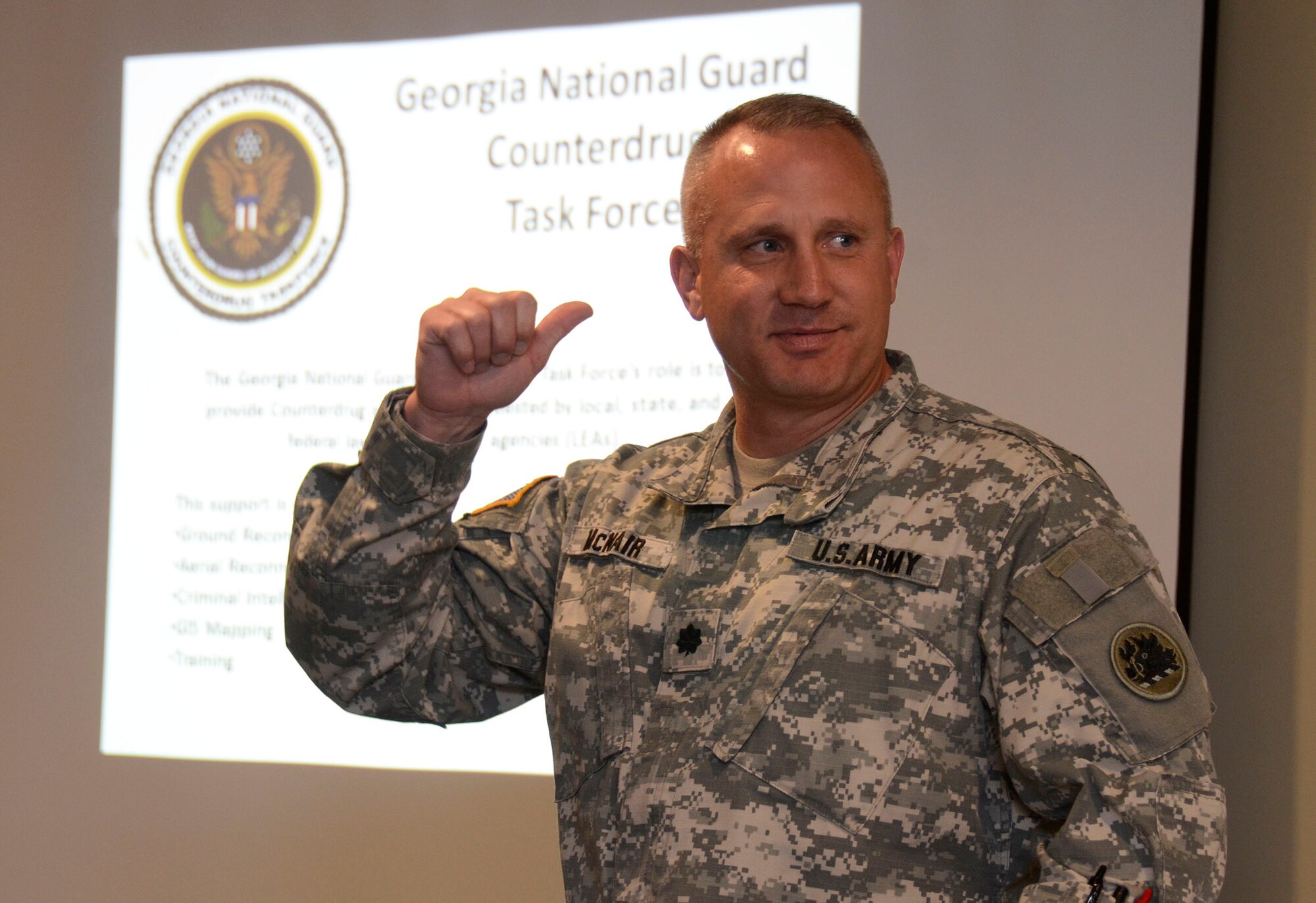 Army Lt. Col. Jay McNair, executive officer, Georgia National Guard Counterdrug Task Force, gives an overview of the military counterdrug task force mission based at Dobbins Air Reserve Base at a Hercules Community Council meeting March 19 at the Dobbins Consolidated Club. The unit is nationally funded to support local, state and federal law enforcement counterdrug agencies with military skills and resources. (U.S. Air Force photo/Don Peek)