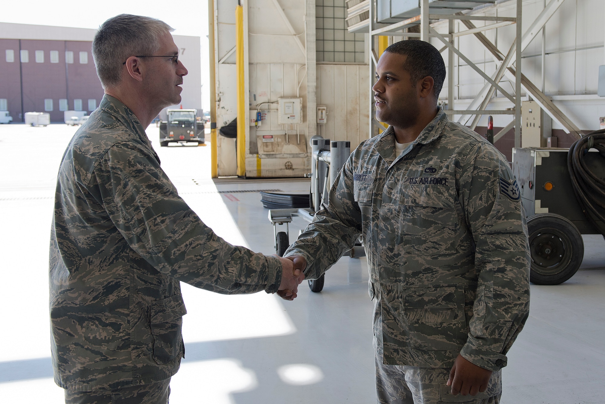 Col. Joel Jackson, 22nd Air Refueling Wing commander, talks to the Airmen of the 22nd Maintenance Squadron electrical and environmental systems flight, March 13, 2014, at McConnell Air Force Base, Kan. Jackson visited to recognize Staff Sgt. Tiron Jarrett, 22nd MXS electrical and environmental systems craftsman for outstanding performance as a supervisor. (U.S. Air Force photo/Airman 1st Class Colby L. Hardin)