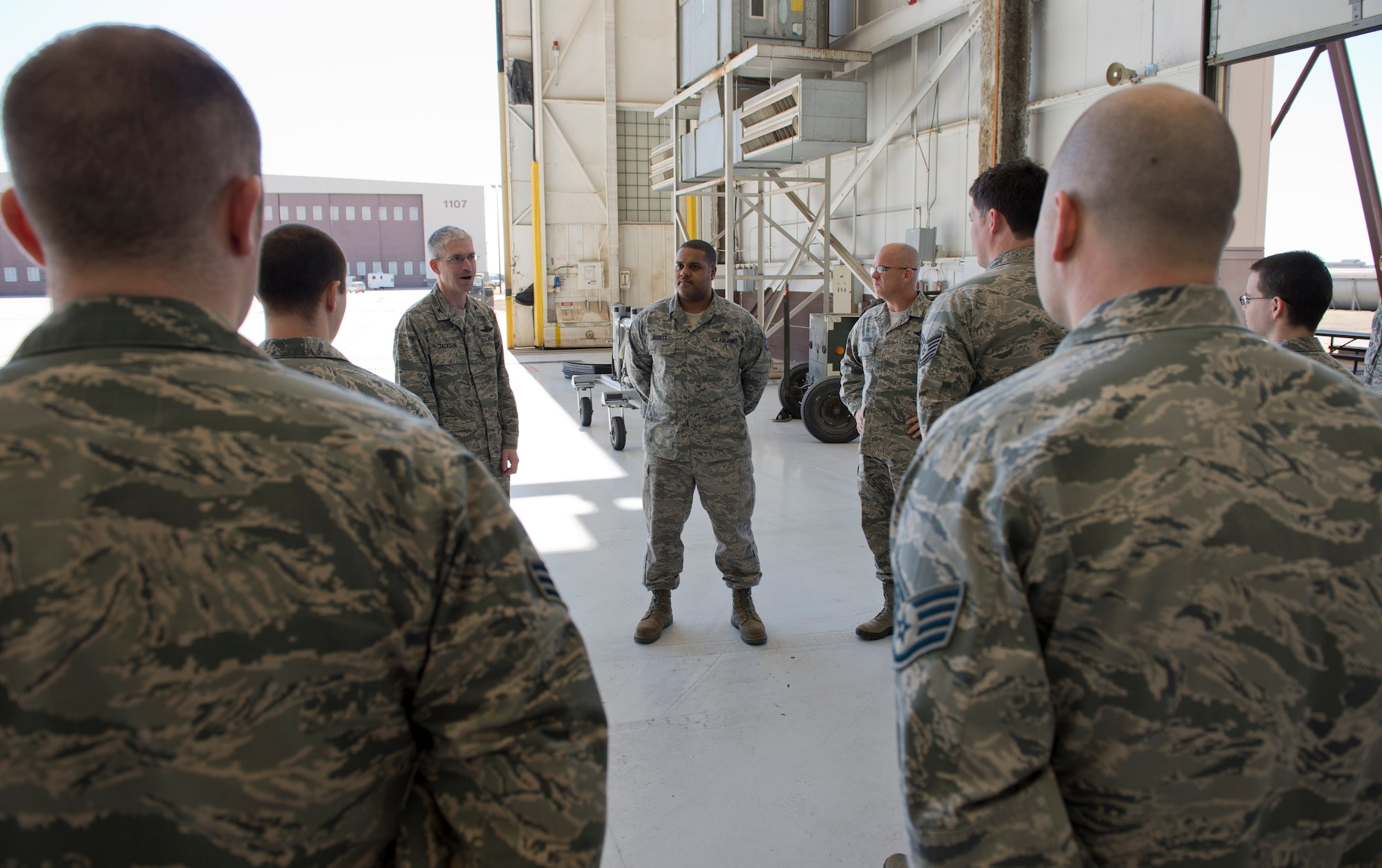 Staff Sgt. Tiron Jarrett, 22nd Maintenance Squadron electrical and environmental systems craftsman, receives a commander’s coin from Col. Joel Jackson, 22nd Air Refueling Wing commander March 13, 2014, at McConnell Air Force Base, Kan. Jarrett was recognized as a standout supervisor by his leadership and Airmen he supervises. (U.S. Air Force photo/Airman 1st Class Colby L. Hardin) 
