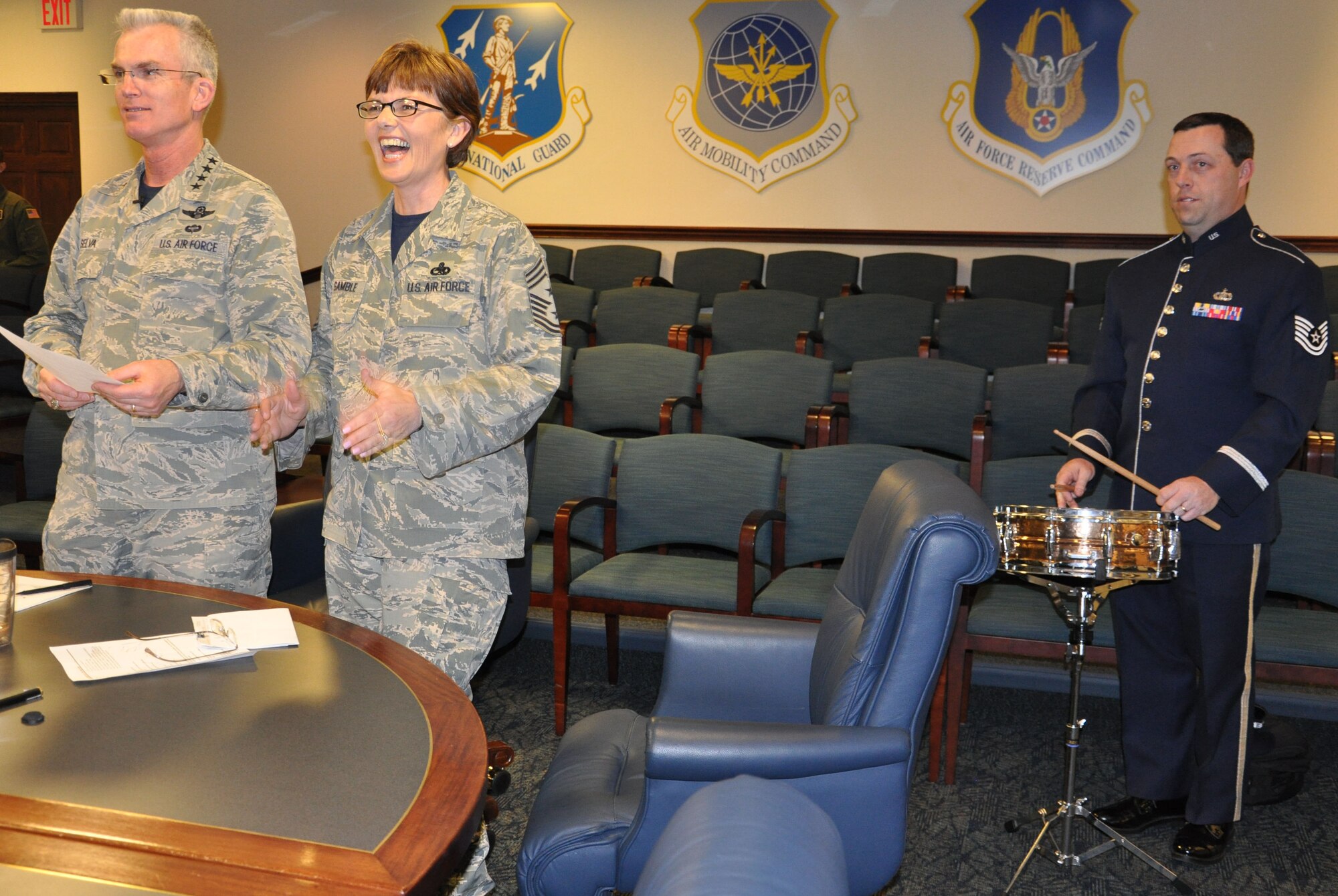 Gen. Paul Selva, Air Mobility Command commander, and Chief Master Sgt. Victoria Gamble, AMC command chief, announce the 2013 AMC Outstanding Airmen of the Year, with Tech. Sgt. Matt Thomas, AMC Band of Mid-America, playing the drum roll, during a command-wide video teleconference at Scott Air Force Base, Ill., March 21, 2014. With the exception of the Honor Guard Team and First Sergeant Council of the Year, all winners will compete for the Air Force 12 Outstanding Airmen of the Year. (U.S. Air Force photo/Staff Sgt. Amber R. Kelly-Herard)  