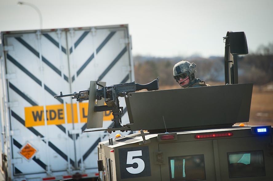 A 91st Missile Security Force Squadron convoy operations member, provides security during a mission in the 91st Missile Wing missile complex, March 12, 2014. Members of the 91st MSFS operate on 12-hour shifts, and are on alert 24/7, 365 days a year, ready to deploy at a moment's notice to launch and missile alert facilities. (U.S. Air Force photo/Tech. Sgt. Aaron Allmon)