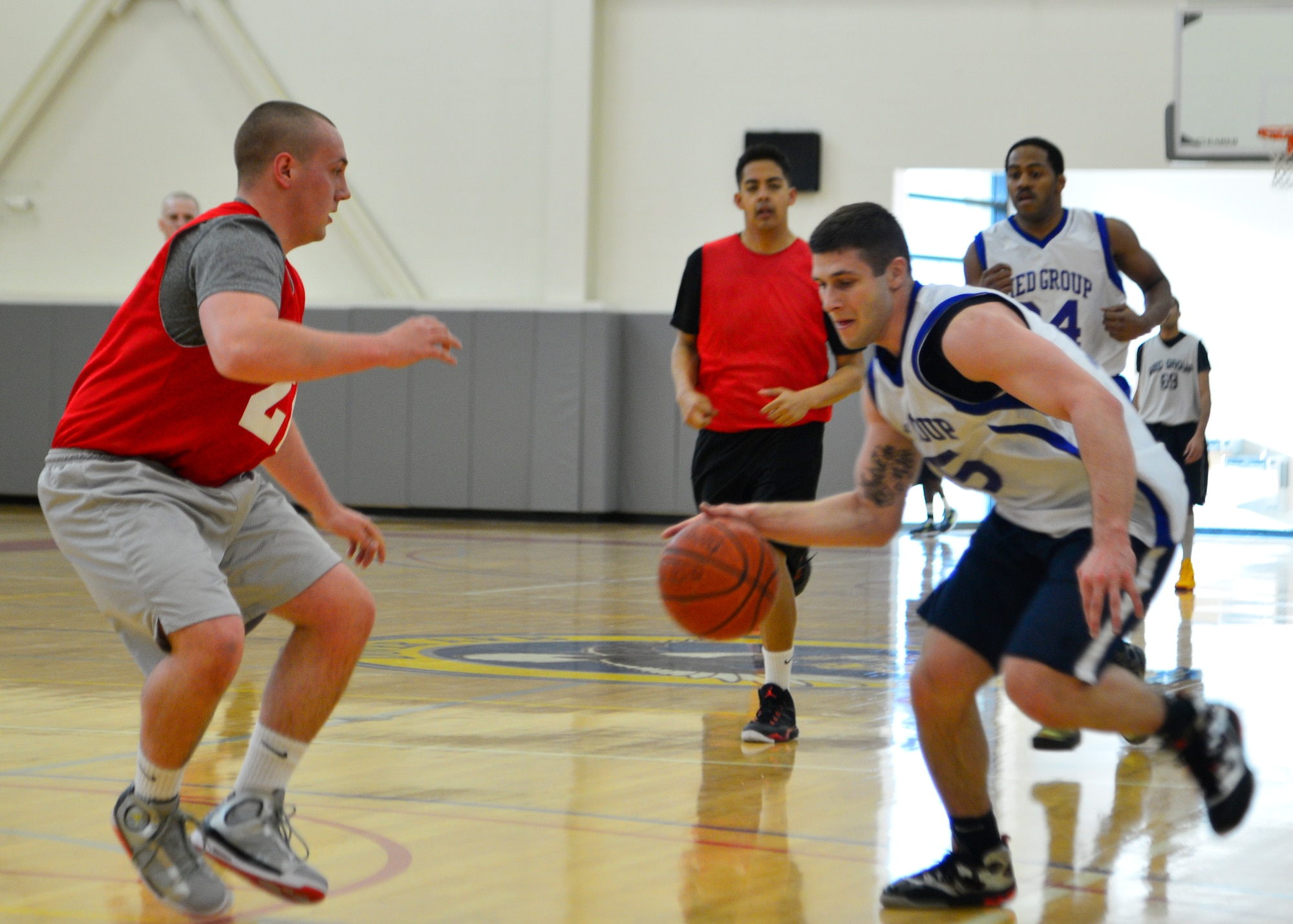 Jason McLanson, 436th Medical Group guard, drives past a 436th Aerial Port Squadron defender during the intramural basketball championship game March 18, 2014, at the fitness center on Dover Air Force Base, Del. The 436th MDG beat the 436th APS 54-27. (U.S. Air Force photo/Airman 1st Class William Johnson)