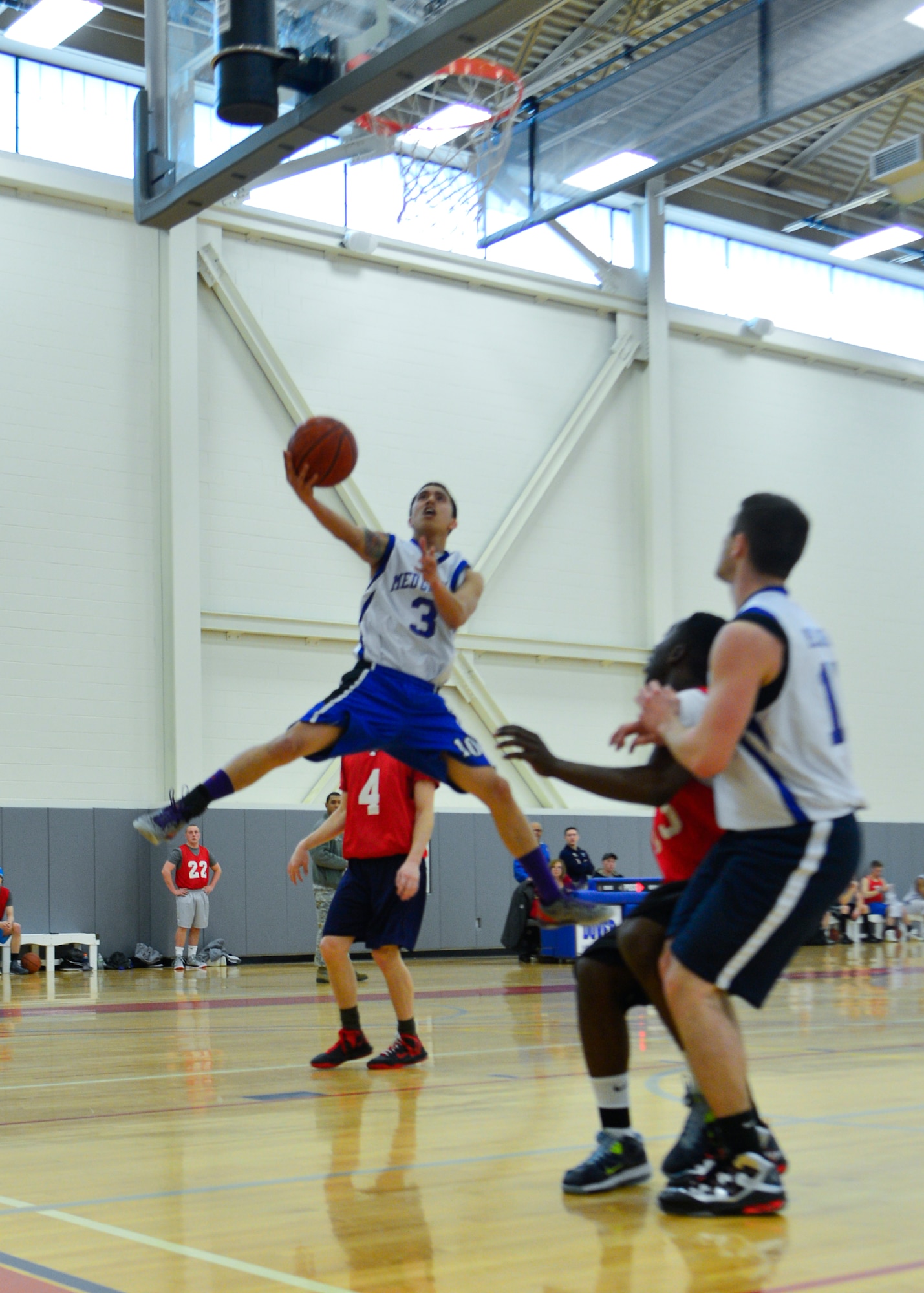 Roger Cabungcel, 436th Medical Group guard, goes up for a lay-up during the intramural basketball championship game against the 436th Aerial Port Squadron March 18, 2014, at the fitness center on Dover Air Force Base, Del. Cabungcel scored nine points to help lead the 436th MDG to the 54-27 victory. (U.S. Air Force photo/Airman 1st Class William Johnson)