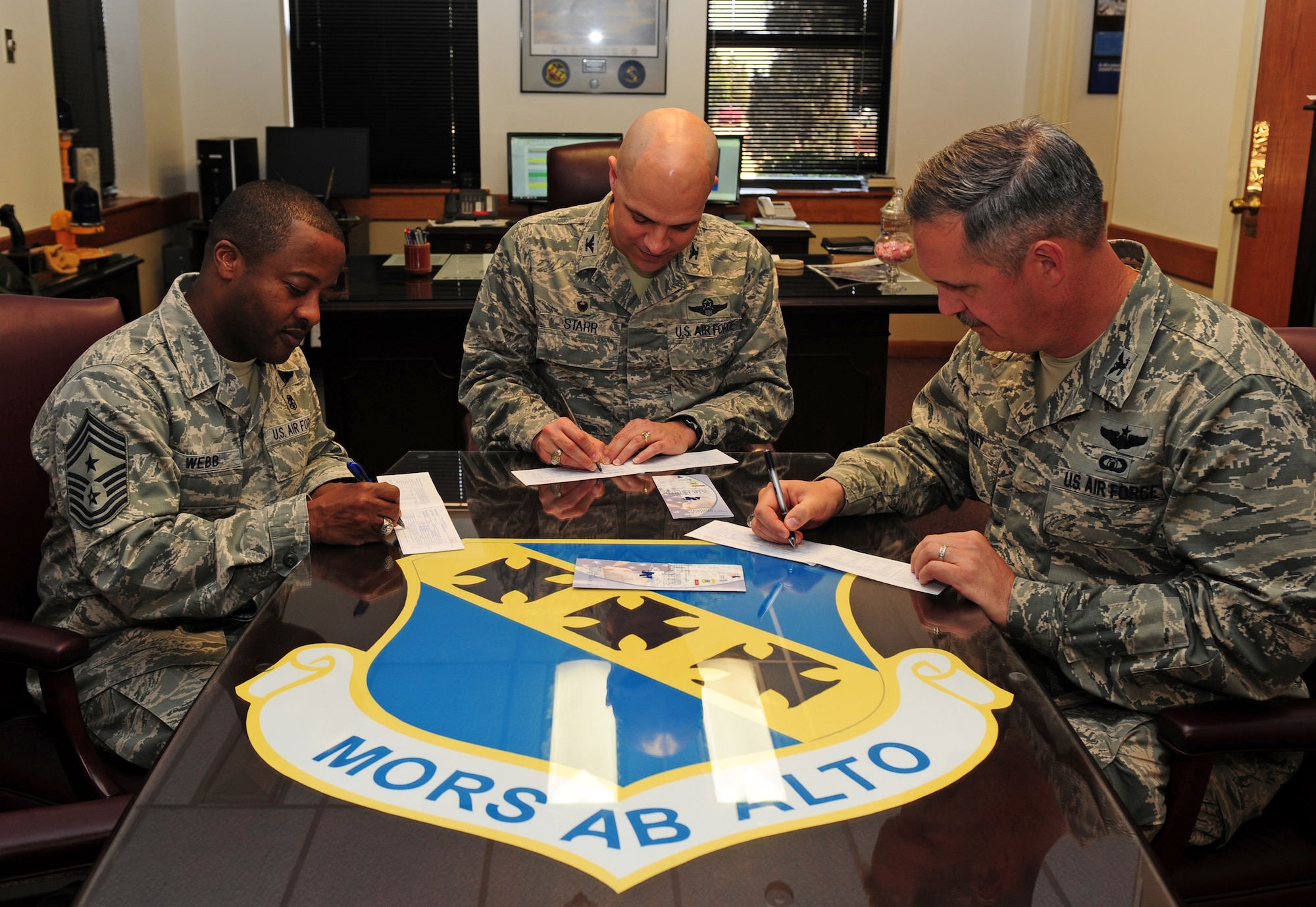 From left, U.S. Air Force Chief Master Sgt. Eddie Webb, 7th Bomb Wing command chief, Col. Michael Bob Starr, 7th BW commander, and Col. Steven Beasley, 7th BW vice commander, fill out their Air Force Assistance Fund donation forms March 20, 2014, at Dyess Air Force Base, Texas. All monies raised during the campaign go to supporting the Air Force’s four charities: the Air Force Villages Charitable Foundation, the General and Mrs. Curtis E. LeMay Foundation, the Air Force Enlisted Village and the Air Force Aid Society. (U.S. Air Force photo by Senior Airman Kia Atkins/Released)