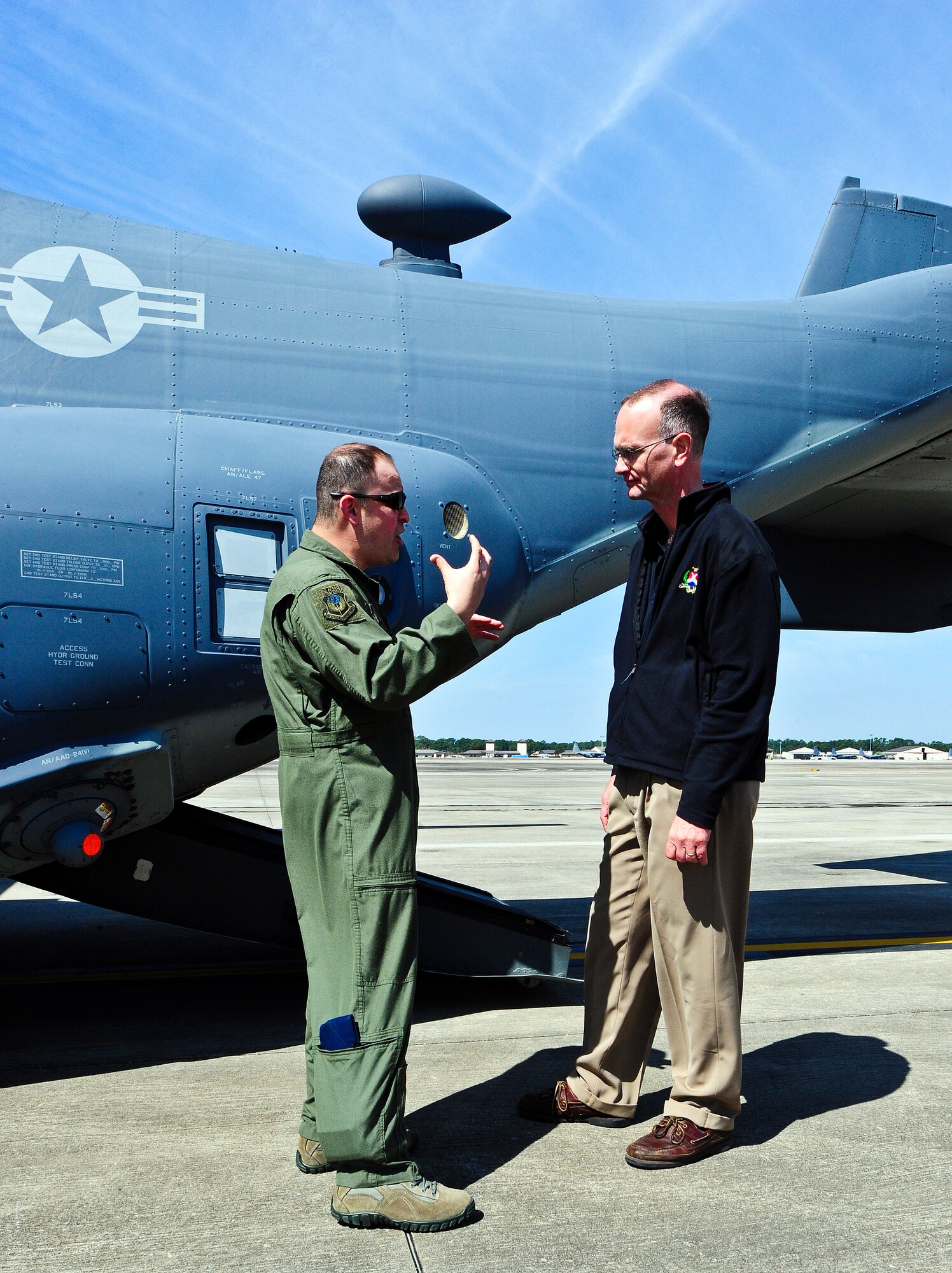 A CV-22 Osprey crewmember explains aircraft operations to Ambassador Gregory Schulte, Department of Defense deputy assistant secretary of defense for space policy, during a tour for National War College students on the flightline at Hurlburt Field, Fla., March 21, 2014.  The students, including service members from all military branches and civilians from various federal departments, visited different military installations as part of their curriculum. (U.S. Air Force photo/Senior Airman Michelle Patten)