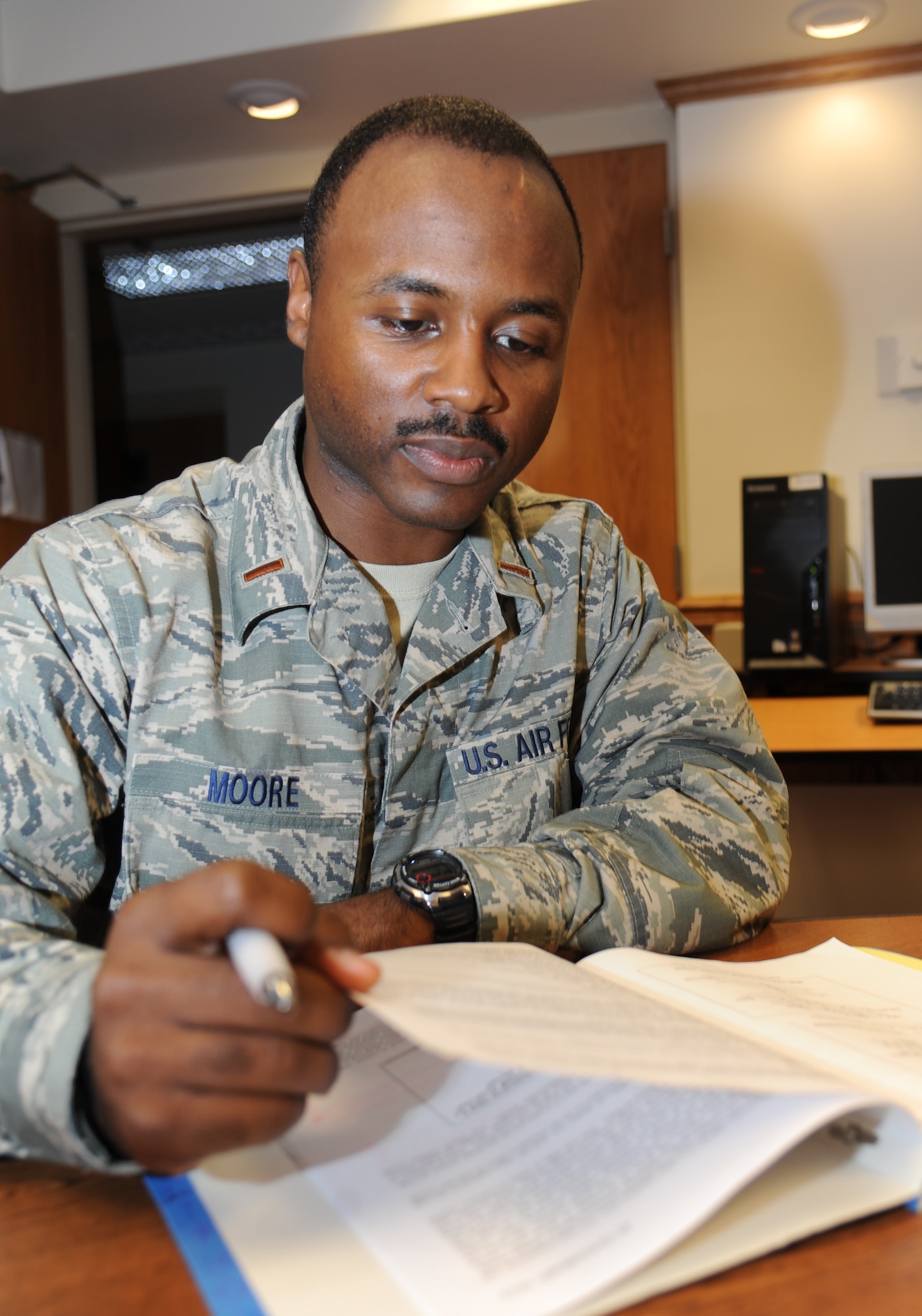 Second Lt. Dari Moore, 335th Training Squadron, reviews notes in the personnel officer course March 21, 2014, at Wolf Hall, Keesler Air Force Base, Miss.  Moore, from Newark, N.J., will be heading back to the 325th Force Support Squadron, Tyndall Air Force Base, Fla.  (U.S. Air Force photo by Kemberly Groue)