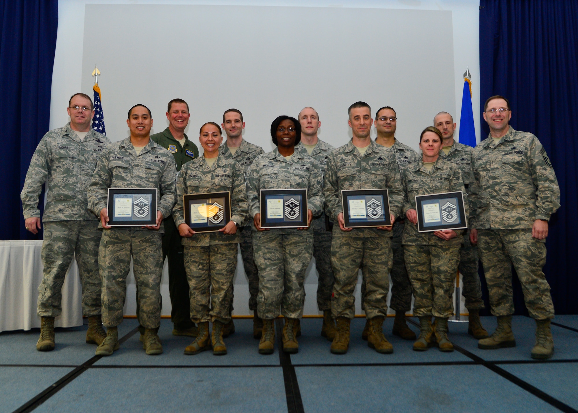 Team Dover Senior Master Sergeant selects pose with Col. Rick Moore, 436th Airlift Wing commander, and Chief Master Sgt. Stanley Cadell, 436th AW command chief, following a ceremony March 20, 2014, at The Landings on Dover Air Force Del. Senior Master Sergeants make up only three percent of the total enlisted force. (U.S. Air Force photo/Airman 1st Class William Johnson)