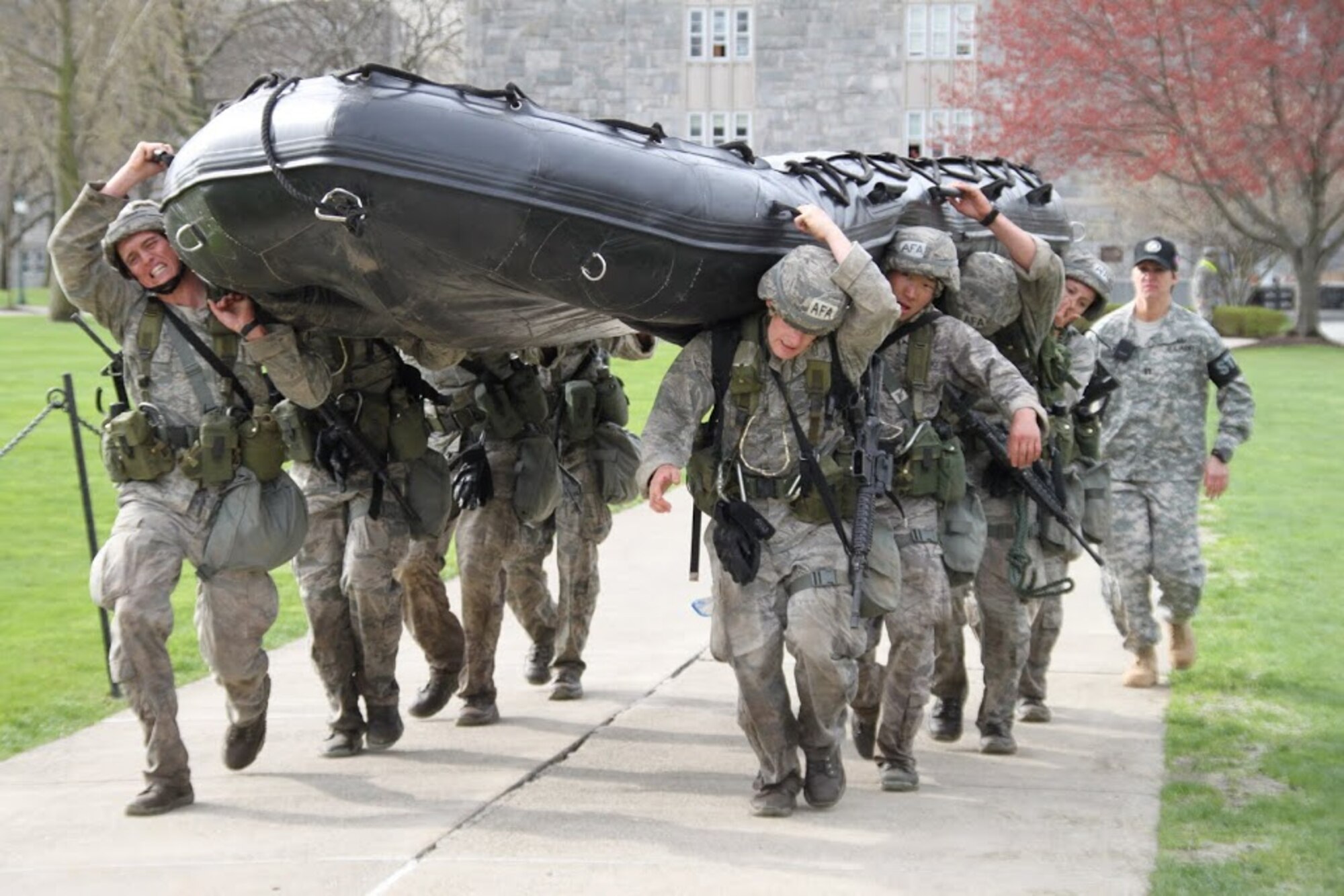 Academy cadets carry a 250-pound Zodiac inflatable boat during the final half-mile of last year's Sandhurst competition at the U.S. Military Academy. (Air Force photo/Tech. Sgt. Jon Hyder)