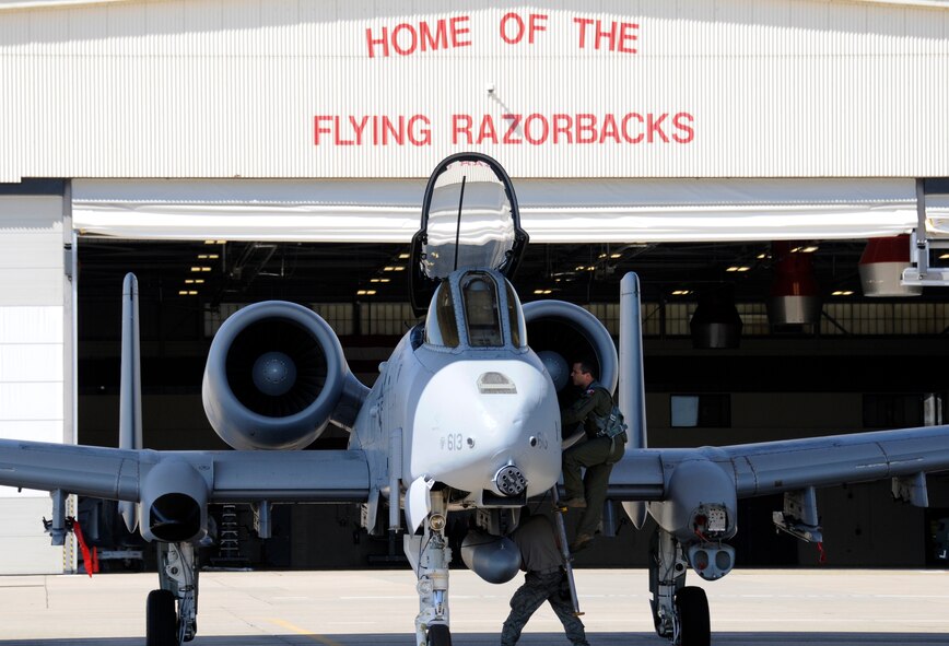 A pilot with the 23rd Wing climbs into the cockpit of a 188th Fighter Wing A-10C Thunderbolt II "Warthog" (Tail No. 613) while Master Sgt. Steve Bunting, a crew chief with the 188th Aircraft Maintenance Squadron, prepares the aircraft for takeoff at Ebbing Air National Guard Base, Fort Smith, Ark. The aircraft was delivered from the 188th Fighter Wing to Moody Air Force Base, Ga., March 11, 2014, as part of the 188th's mission conversion from the A-10 to a remotely piloted aircraft, intelligence and targeting mission. The 188th has five remaining A-10s on station. The next A-10 is slated to depart in April. The final two aircraft are scheduled to leave the 188th June 7, 2014. (U.S. Air National Guard photo by Tech Sgt. Josh Lewis/Released)