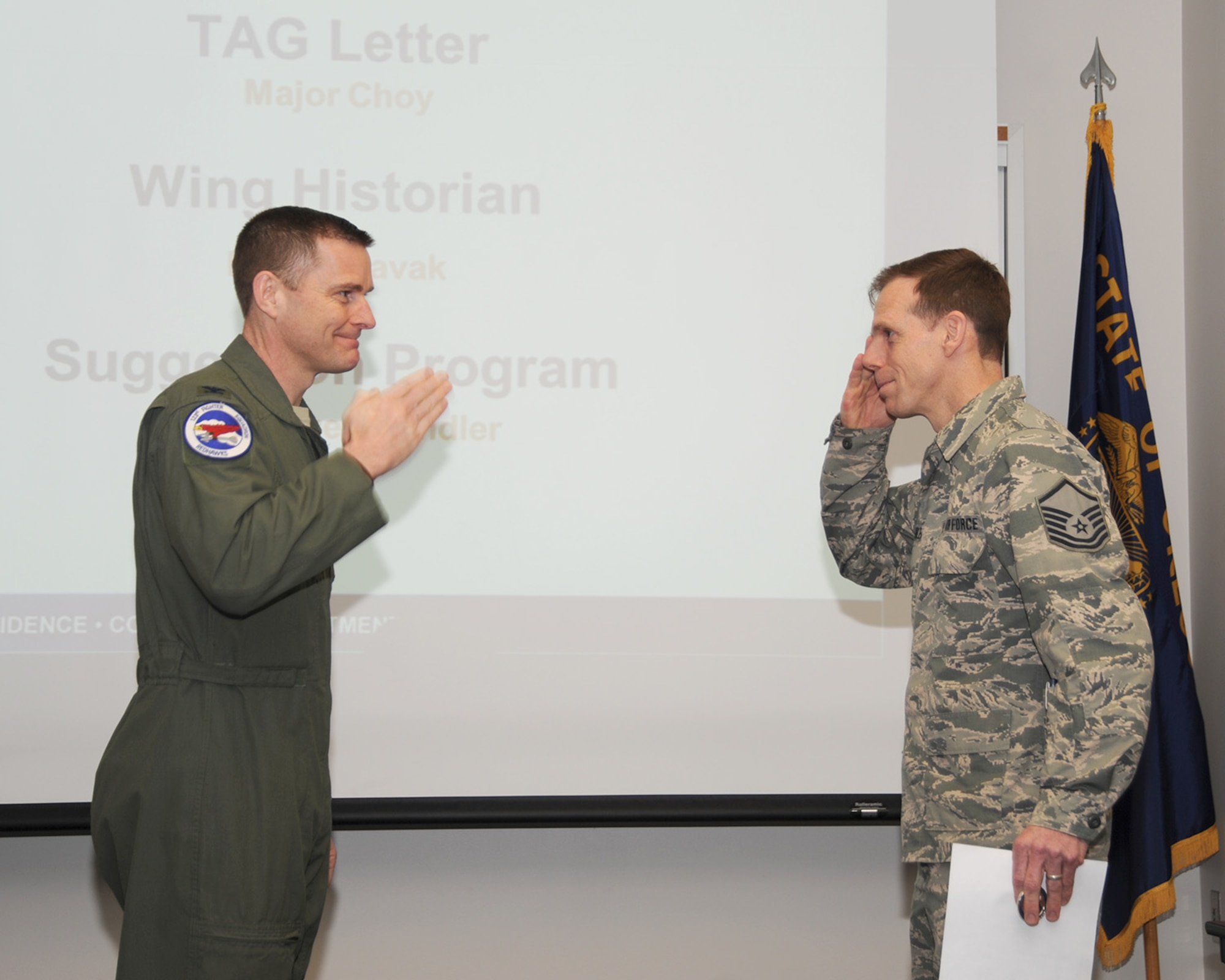 Oregon Air National Guard Col. Rick Wedan, 142nd Fighter Wing commander, salutes Master Sgt. Michael Chandler after presenting him with a certificate for his award under the Air Force’s “Every Dollar Counts” campaign, Portland Air National Guard Base, Ore., Feb. 28, 2014.  (U.S. Air National Guard photo by Master Sgt. Shelly Davison, 142nd Fighter Wing Public Affairs/Released)