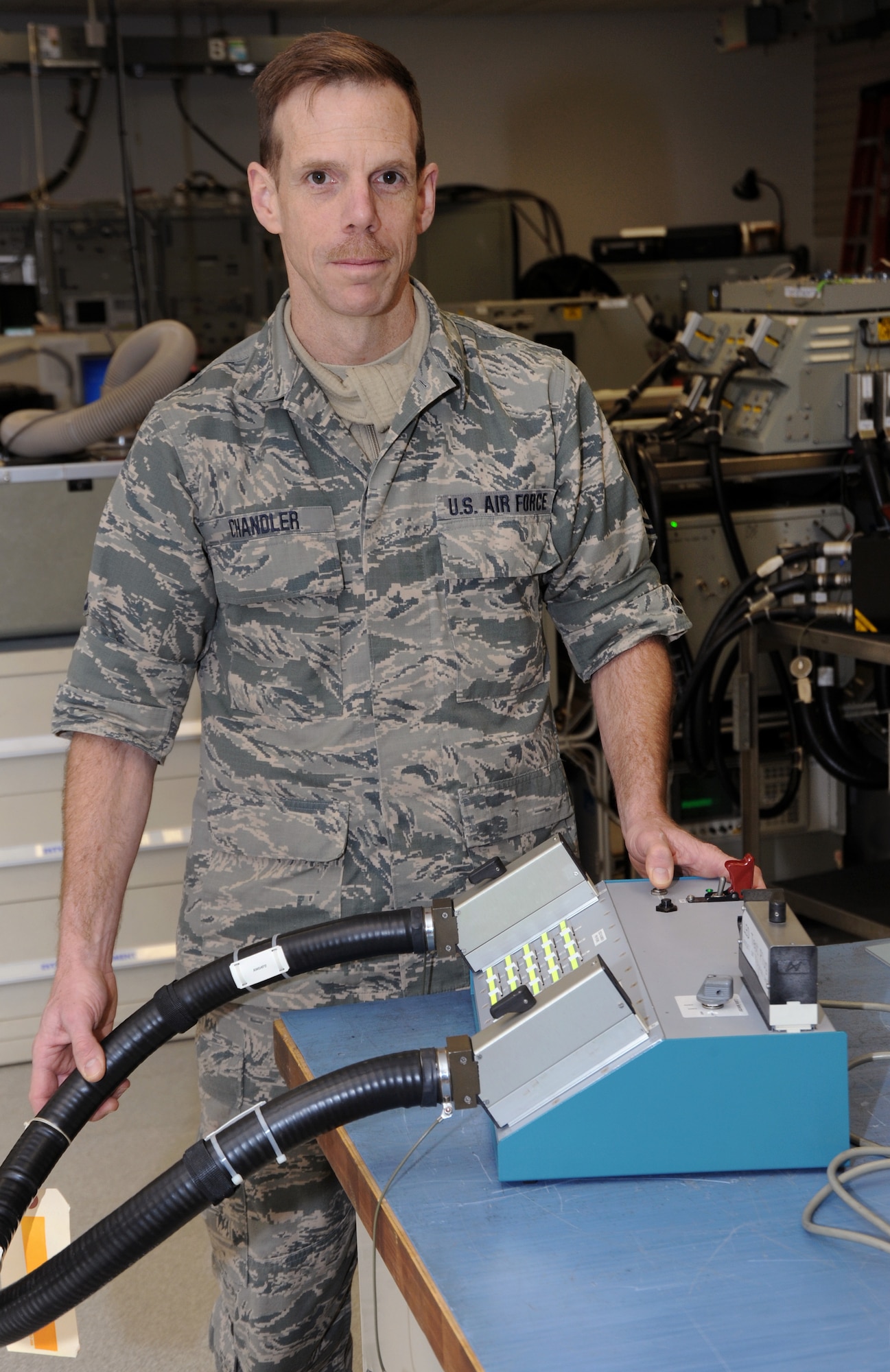 Oregon Air National Guard Master Sgt. Michael Chandler, 142nd Fighter Wing Aircraft Maintenance avionics back shop technician, displays the AW Cable Tester he designed that recently was submitted to the U.S. Air Force, "Every Dollar Counts." campaign and was awarded $5,000.00., Portland Air National Guard Base, Ore., Mar. 21, 2014. (U.S. Air National Guard photo by Tech. Sgt. John Hughel, 142nd Figher Wing Public Affairs/Released)