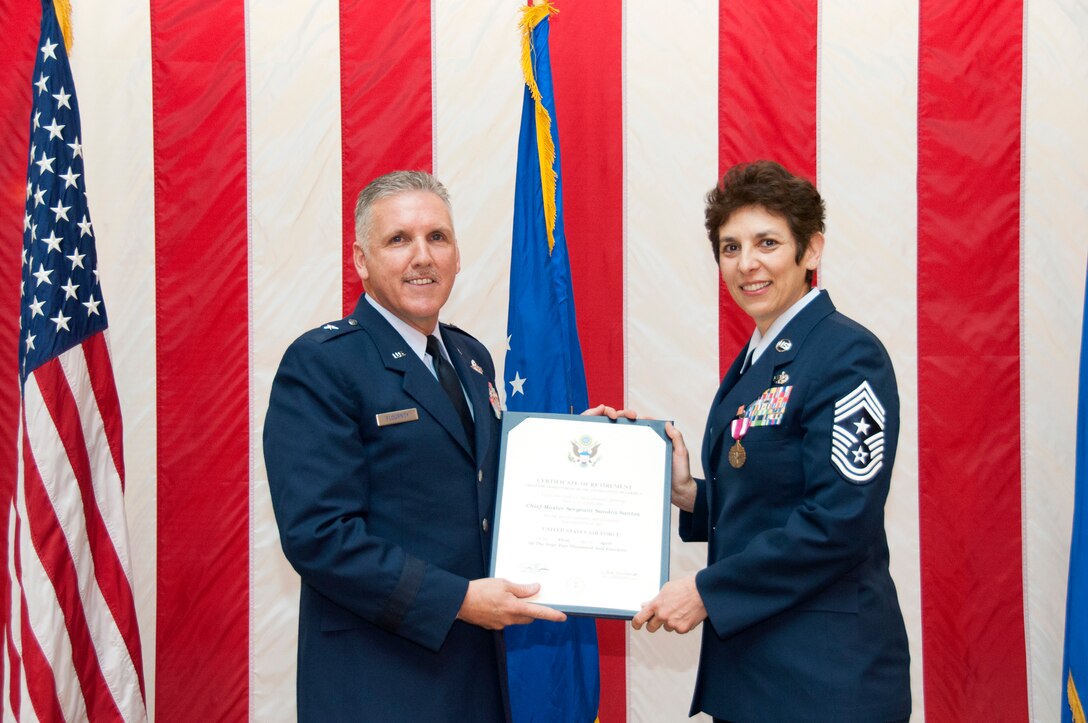 TRAVIS AIR FORCE BASE, Calif. -- Chief Master Sgt. Sandra "Sunny" Santos, 349th Air Mobility Wing, retired after nearly 33 years of service at a ceremony March 9, at Travis Air Force Base, Calif. (U.S. Air Force photos / Master Sgt. Rachel Martinez)

