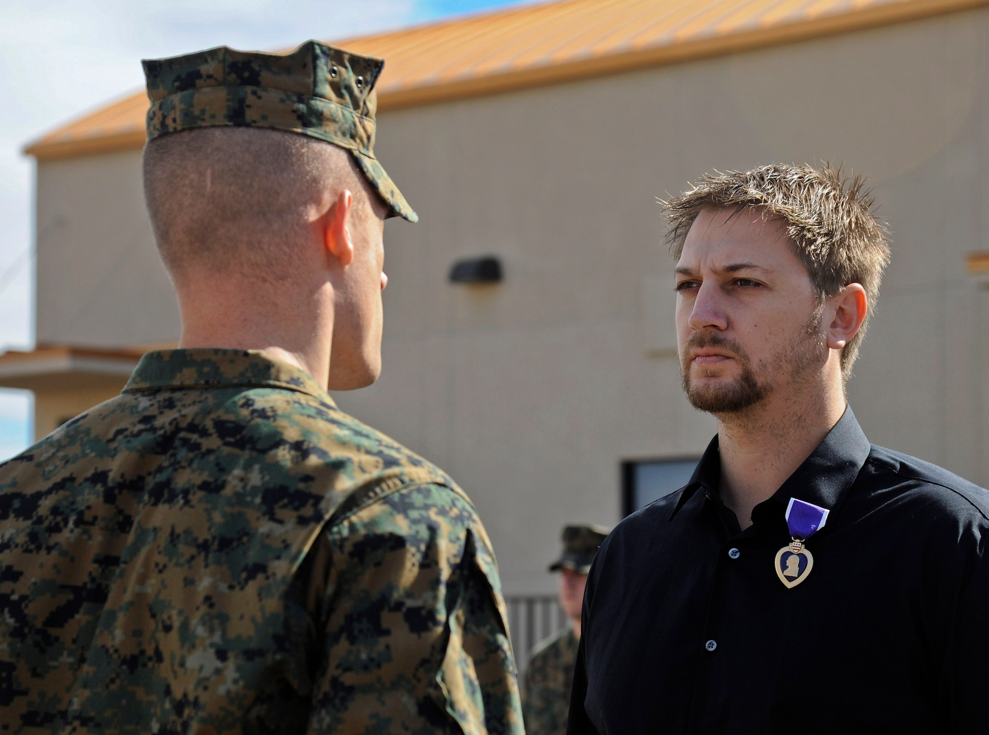 U.S. Marine Corps Capt. David Sierleja, Bulk Fuel Company inspector instructor, pins the Purple Heart on medically retired Staff Sgt. Keith Darnell Feb. 7 at Luke Air Force Base. Darnell received the award for injuries he sustained while deployed to Afghanistan. (U.S. Air Force photo/Staff Sgt. Darlene Seltmann)