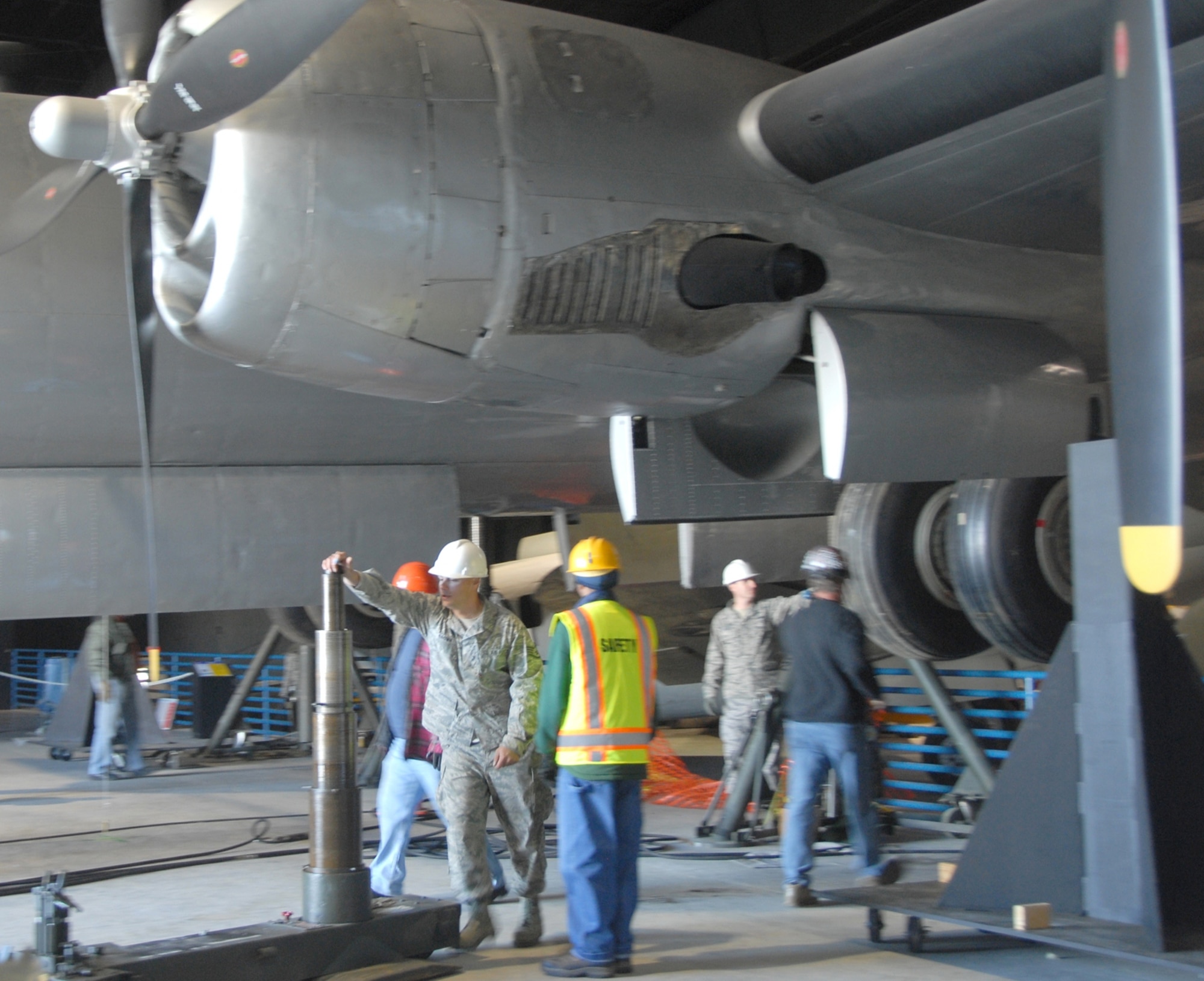 Exhibit specialists aided by the 402nd Expeditionary Depot Maintenance Group work to lift a B-29 Bomber on display at the Museum of Aviation World War II Hangar March 13, 2014.  (U.S. Air Force photo by Misuzu Allen)