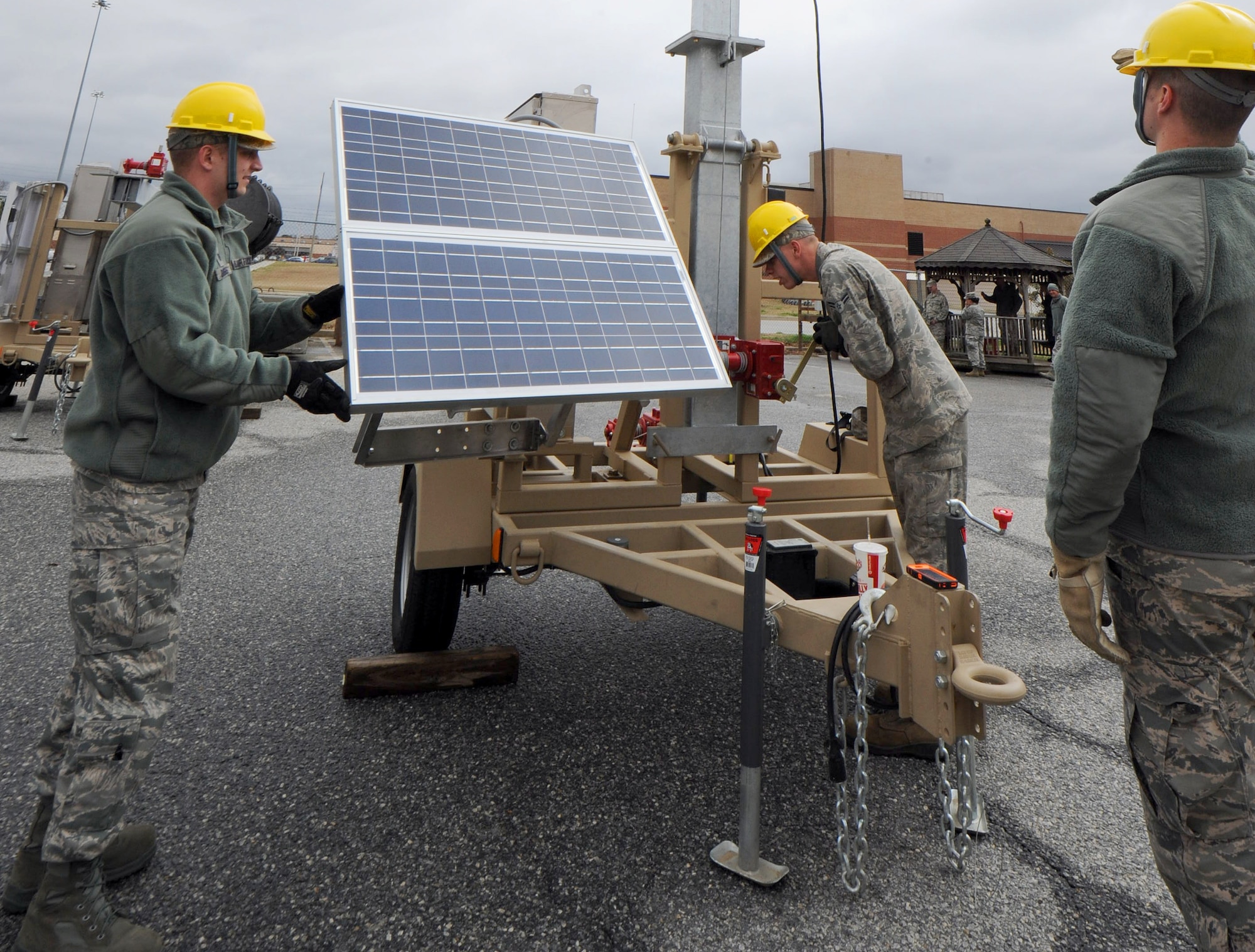 (From left to right) Tech. Sgt. Jason Douglas, RF Transmission Systems supervisor, Airman 1st Class Robert Ringer III, and Senior Airman Jesse Turner, RF Transmission Systems technicians, position the Giant Voice system for the demo.  (U.S. Air Force photo by Tommie Horton)