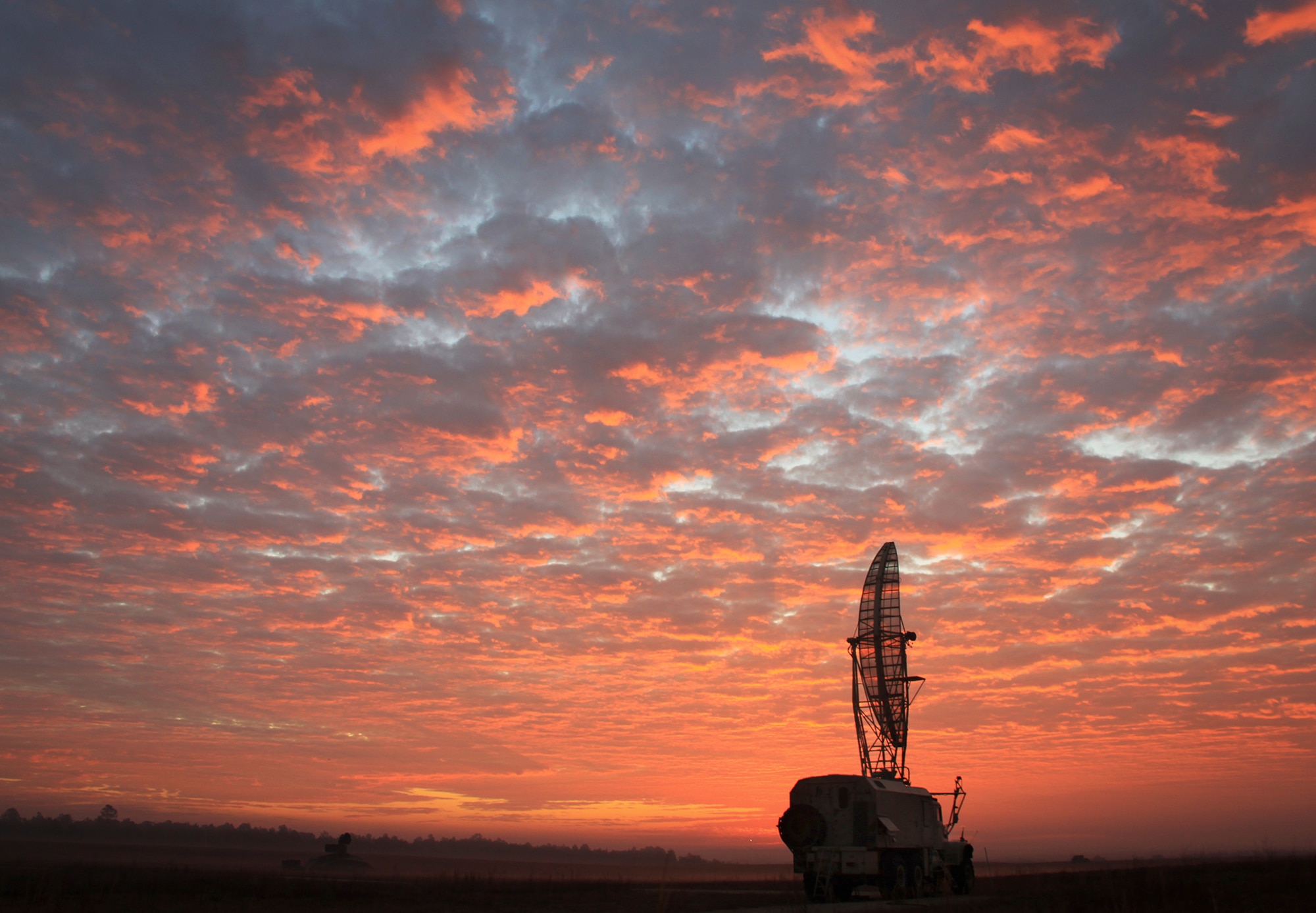 A Height Finding Radar sits idly on the range as the sun is rising March 11 at Eglin Air Force Base, Fla. The radar is one of many devices used for seeker/sensor testing during Sensor Week  March 3 -14. Sensor Week, hosted every two years by Project Chicken Little of the 46th Test Squadron’s Sensor and Defensive Systems Test Flight, is an Air Combat Command sponsored cost-shared opportunity between the government and interested participants to collect data against foreign and domestic test items in both static and dynamic environments. (U.S. Air Force photo/Jeremy Brown)