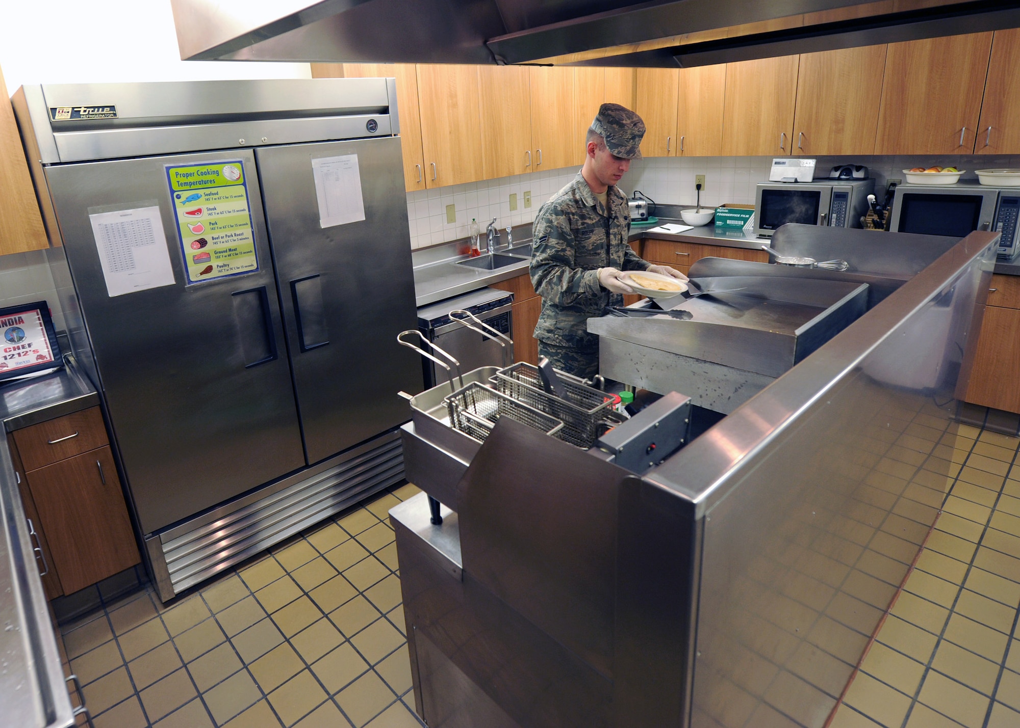 Airman 1st Class Brian Roupp, 341st Force Support Squadron missile chef, cooks chicken breasts during a lunch period at a missile alert facility. Missile chefs individually prepare all the food at Malmstrom’s MAFs and have the opportunity to serve unique, creative cuisines for missileers, maintainers and security forces members. (U.S. Air Force photo/Senior Airman Katrina Heikkinen)