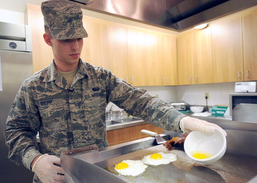 Airman 1st Class Brian Roupp, 341st Force Support Squadron missile chef, fries eggs to make a signature dish – bacon, egg and cheese breakfast sandwich – for a missileer during a lunch period at a missile alert facility. More than 60 missile chefs are assigned to Malmstrom Air Force Base. (U.S. Air Force photo/Senior Airman Katrina Heikkinen)