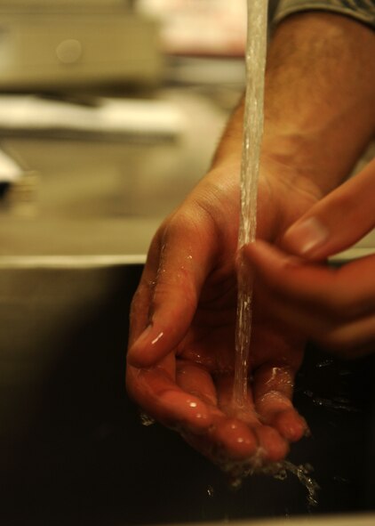 Airman 1st Class Brian Roupp, 341st Force Support Squadron missile chef, washes his hands before preparing lunch for Airmen posted to a missile alert facility. Roupp was recently evaluated on job knowledge and performance and received the highest score possible with zero deviations. (U.S. Air Force photo/Senior Airman Katrina Heikkinen)